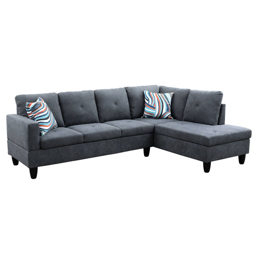 Dark grey sectional sofa with tufted seats and striped pillows