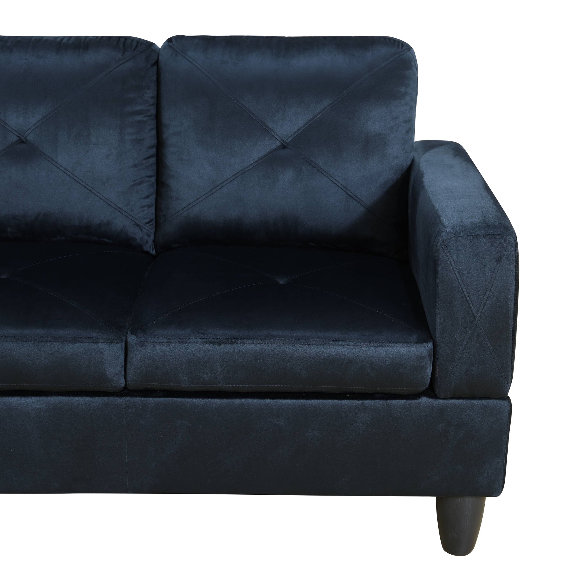 Navy velvet sofa with diamond tufting on back cushions