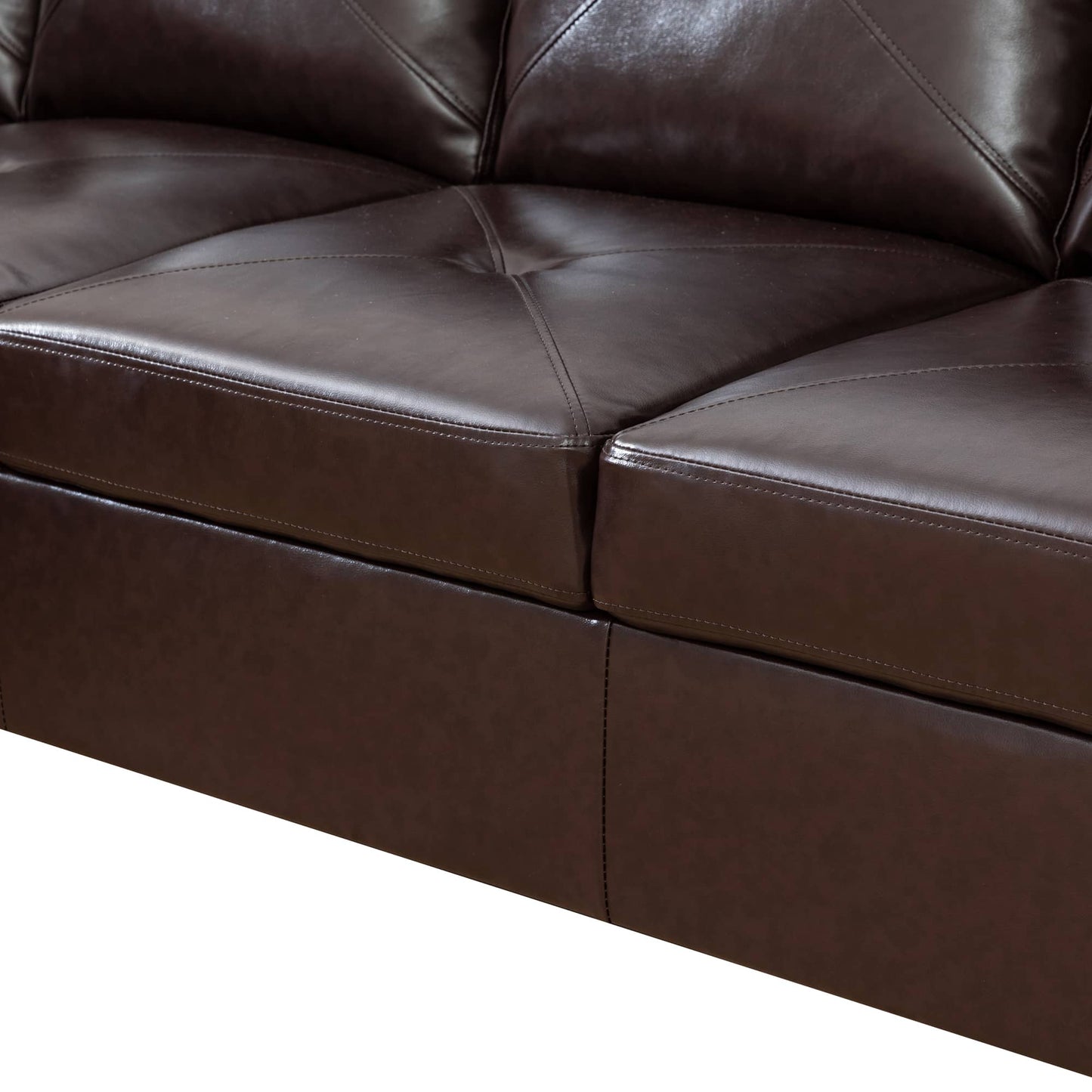 Closeup of dark brown faux leather sofa cushions with diamond stitching