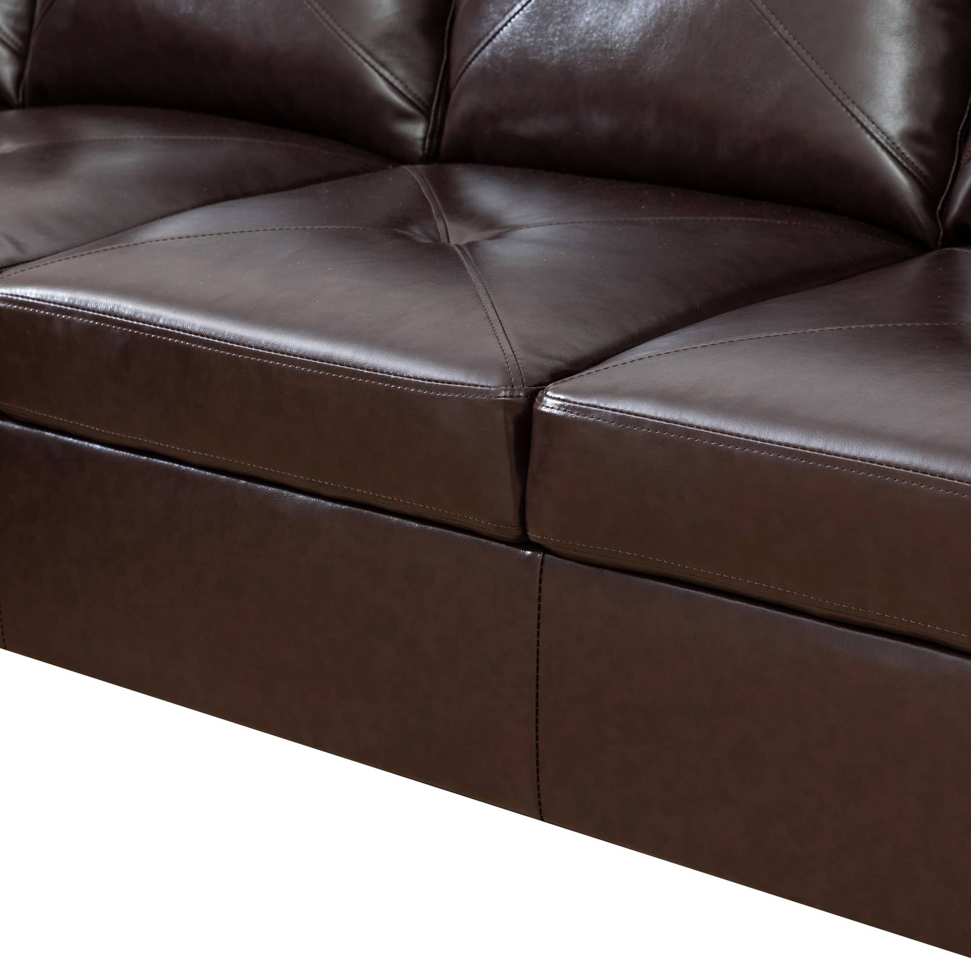 Closeup of dark brown faux leather sofa cushions with diamond stitching