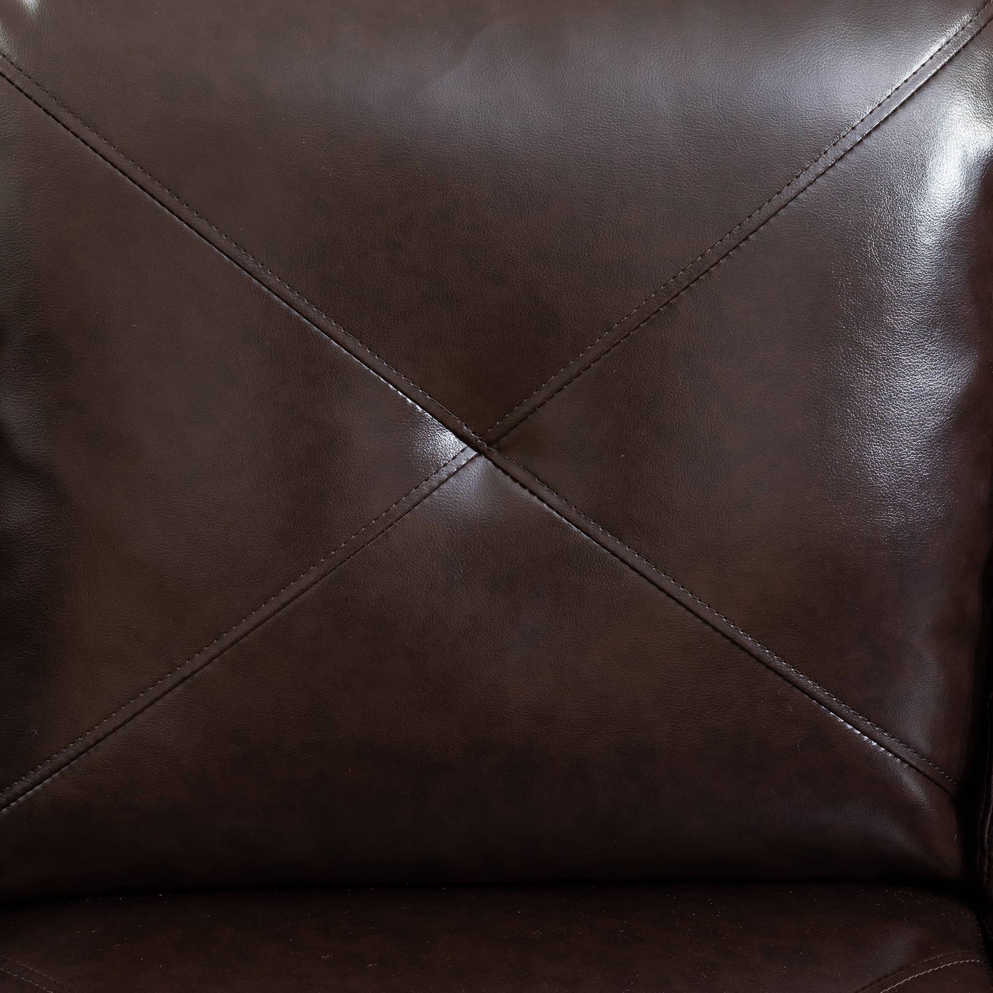 Closeup of stitched dark brown faux leather upholstery on a recliner