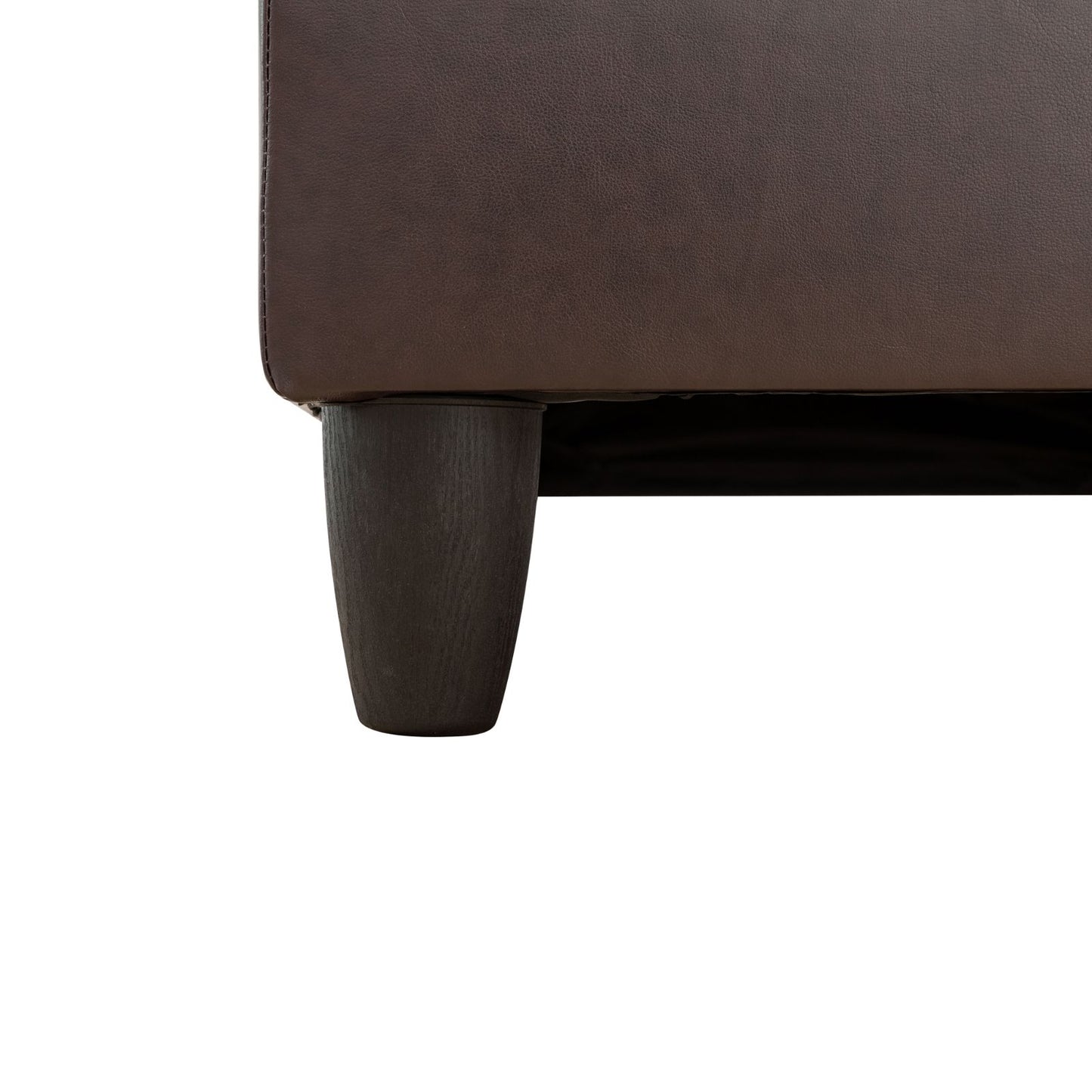 Dark brown faux leather sofa armrest detail with conical dark wood leg
