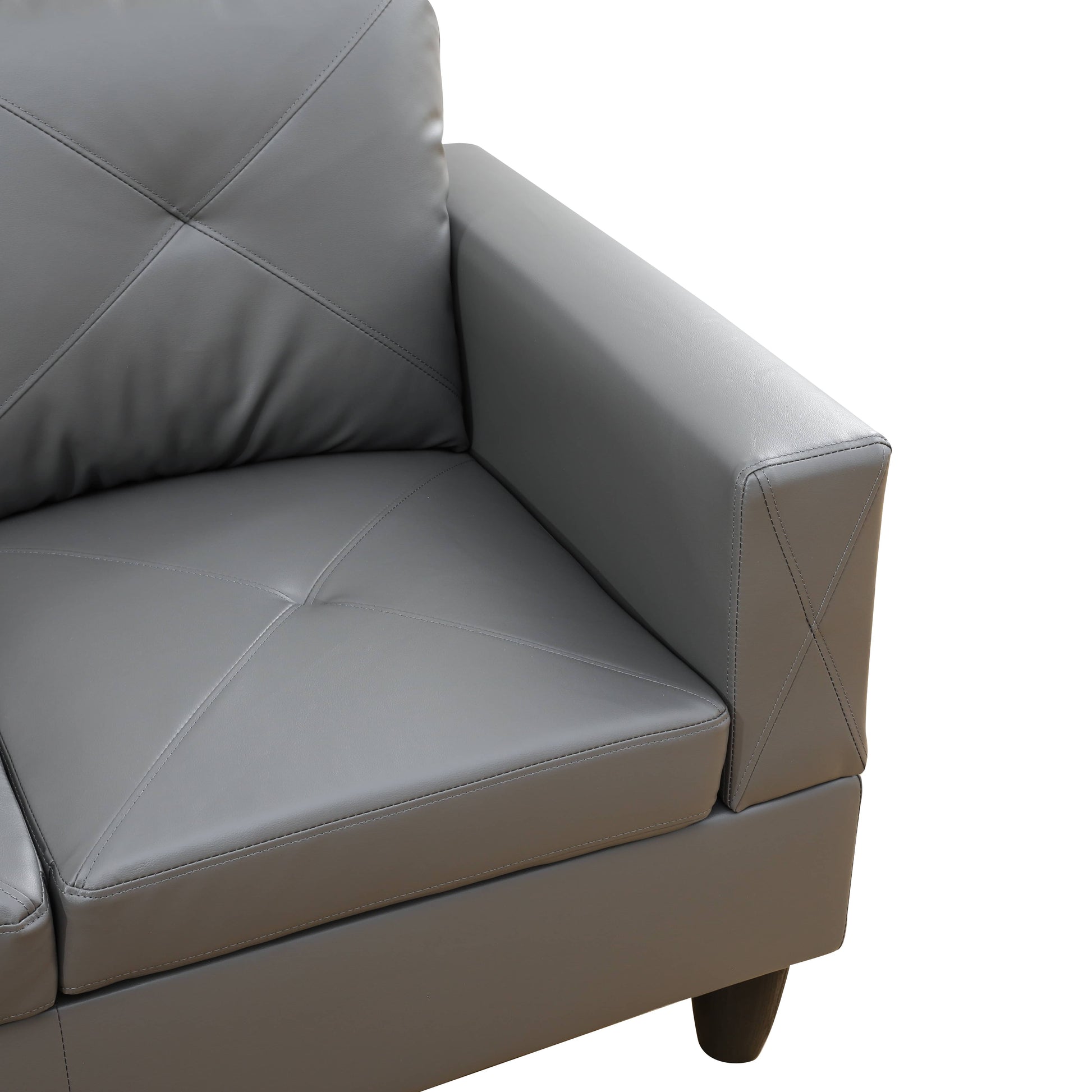 Gray faux leather sofa with diamond tufting on the seat and back cushion