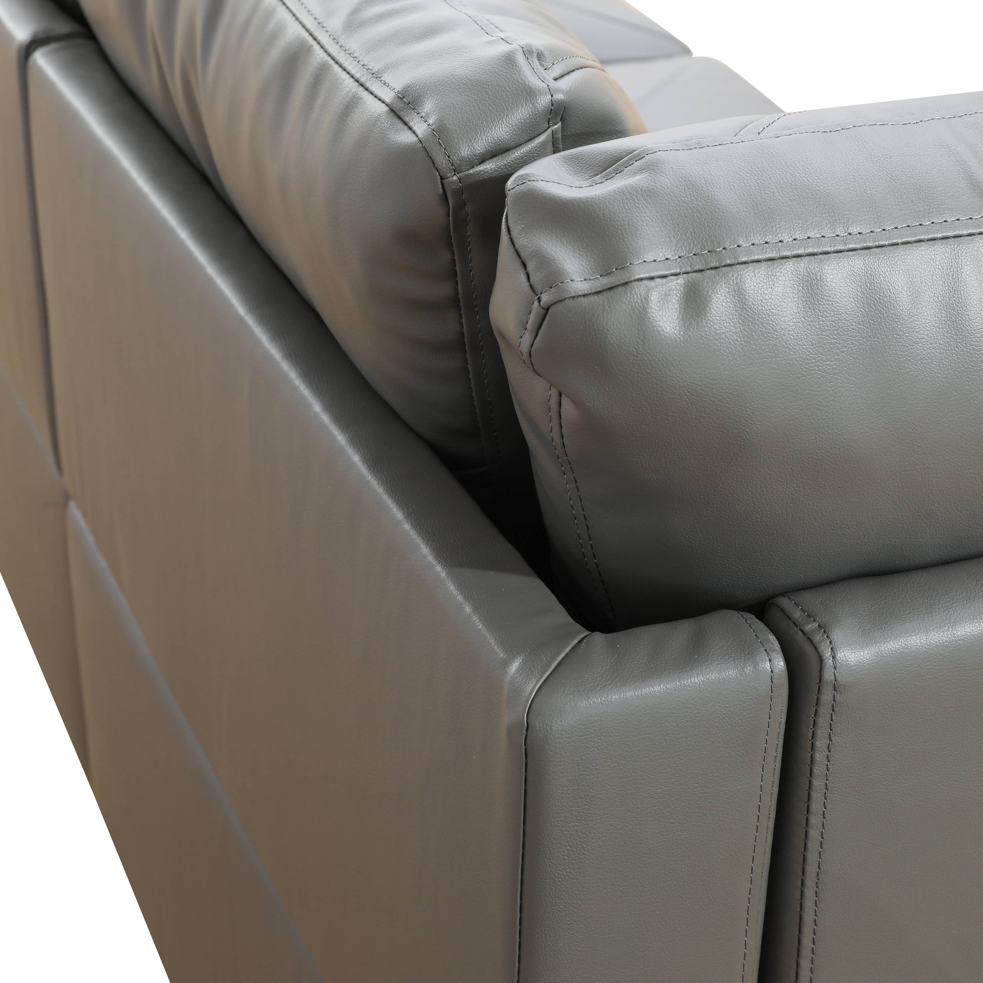 Closeup of stitched grey leather sofa cushions showing texture