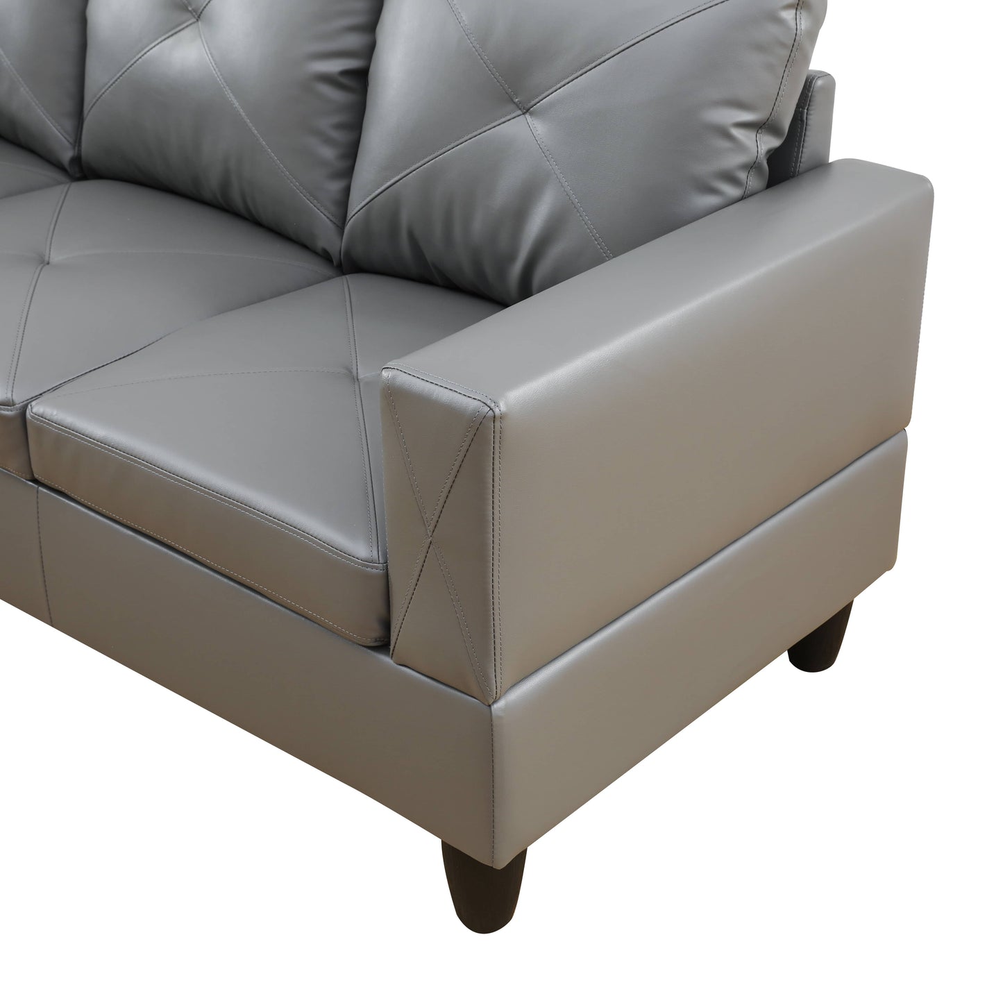 Gray faux leather sofa with diamond stitching on cushions and squared arms