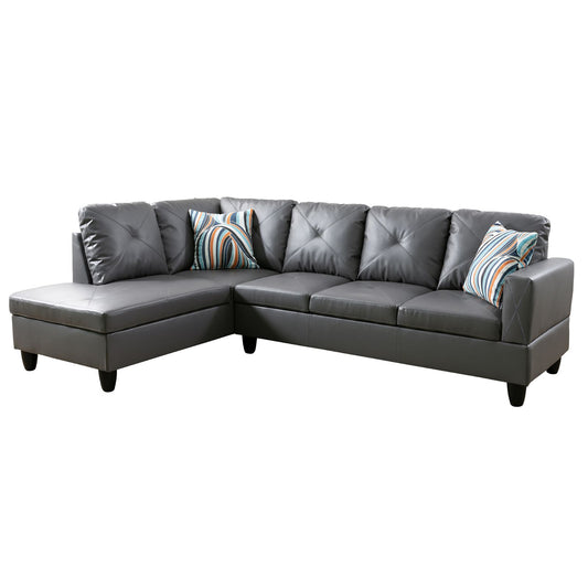 Gray faux leather sectional sofa with diamond tufting and striped accent pillows