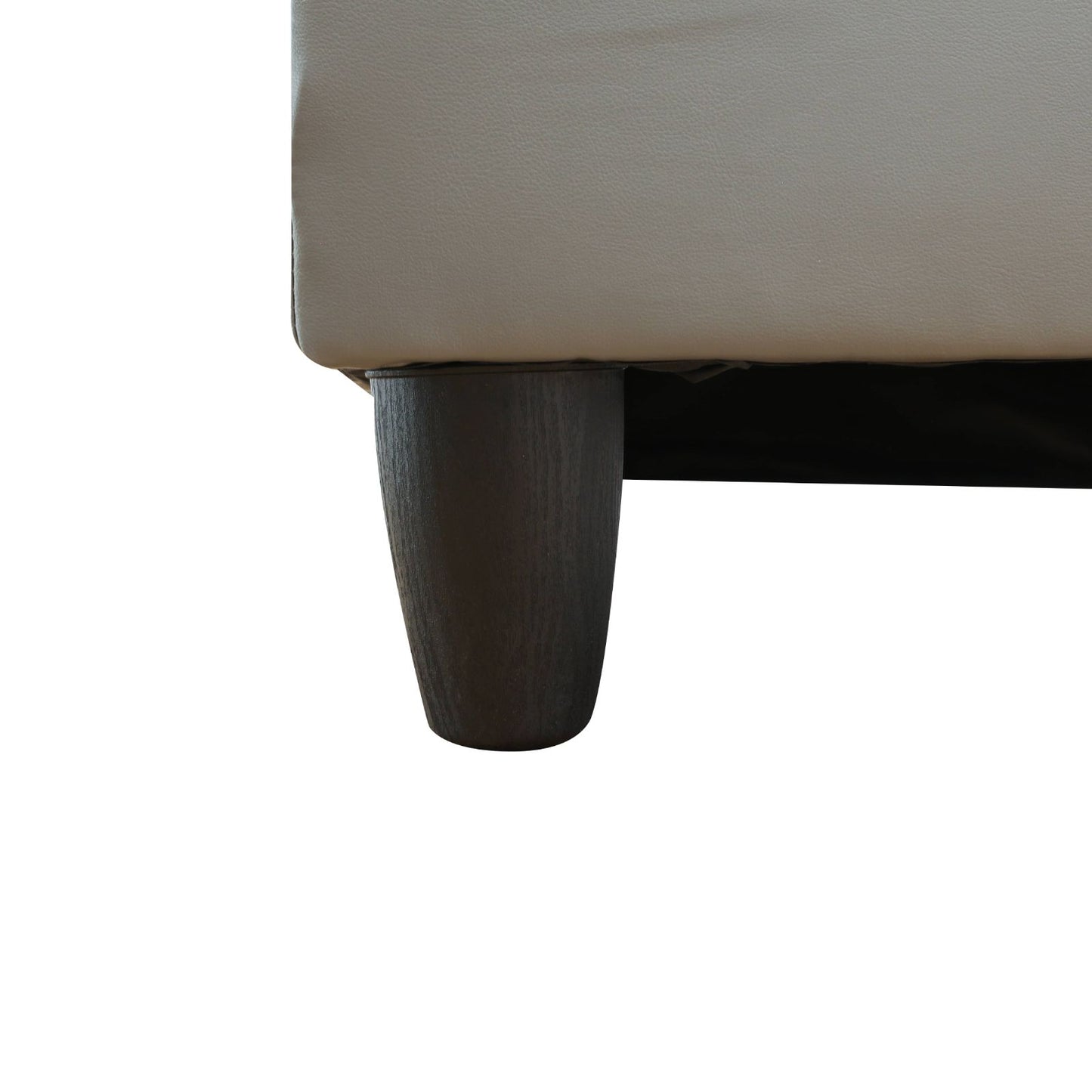 Modern grey leather sofa detail with tapered dark wood leg