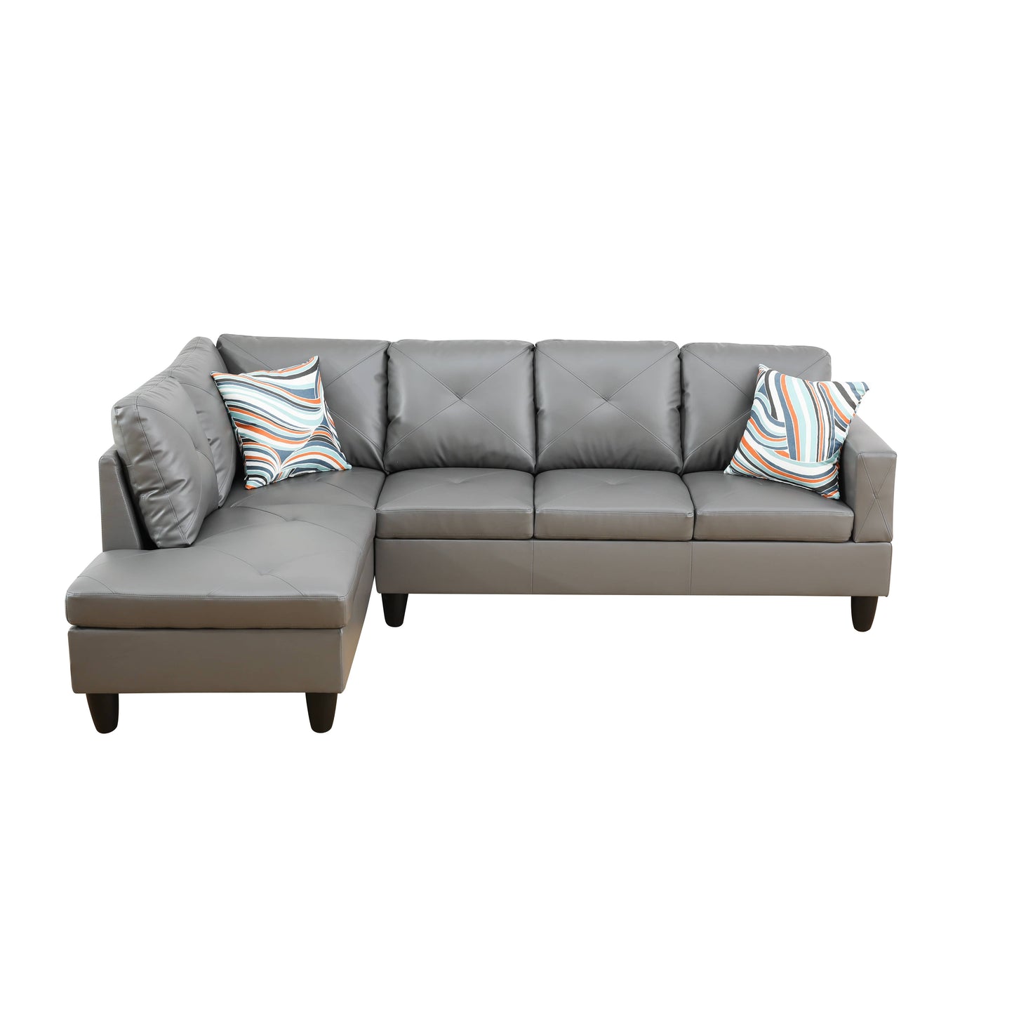 Gray faux leather sectional sofa with diamond tufted cushions and patterned accent pillows