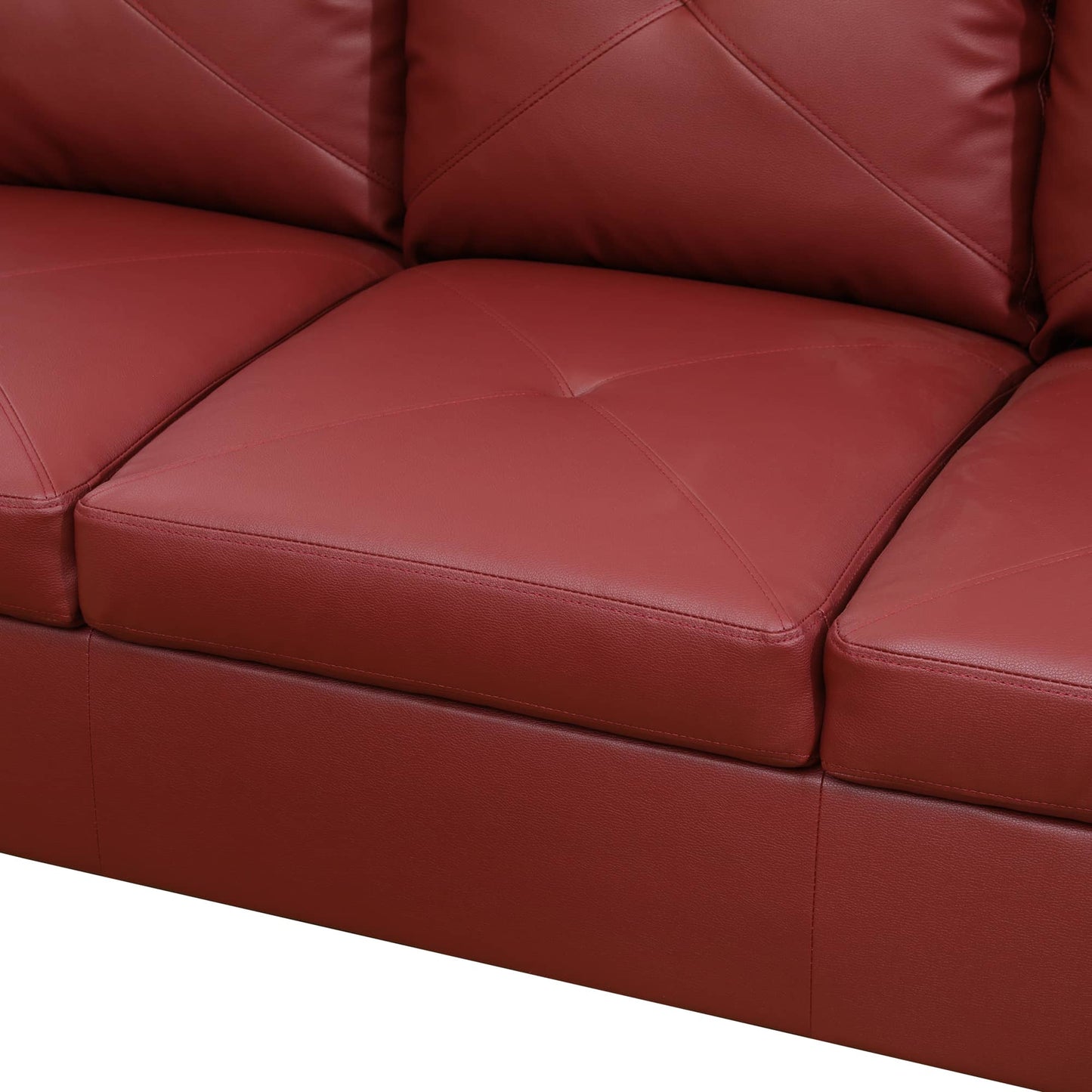 Red faux leather sectional sofa with tufted cushions