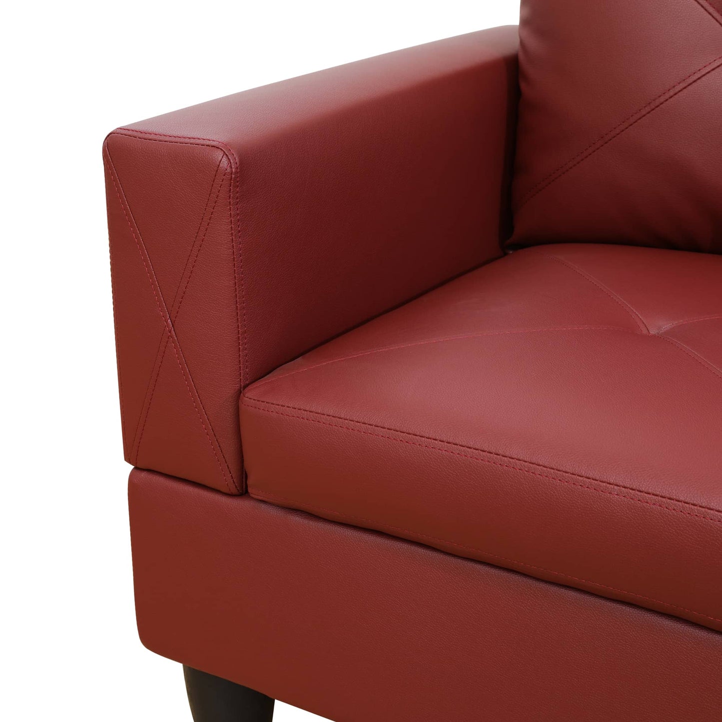 Closeup of a plush red leather sofa arm with diamond stitching detail