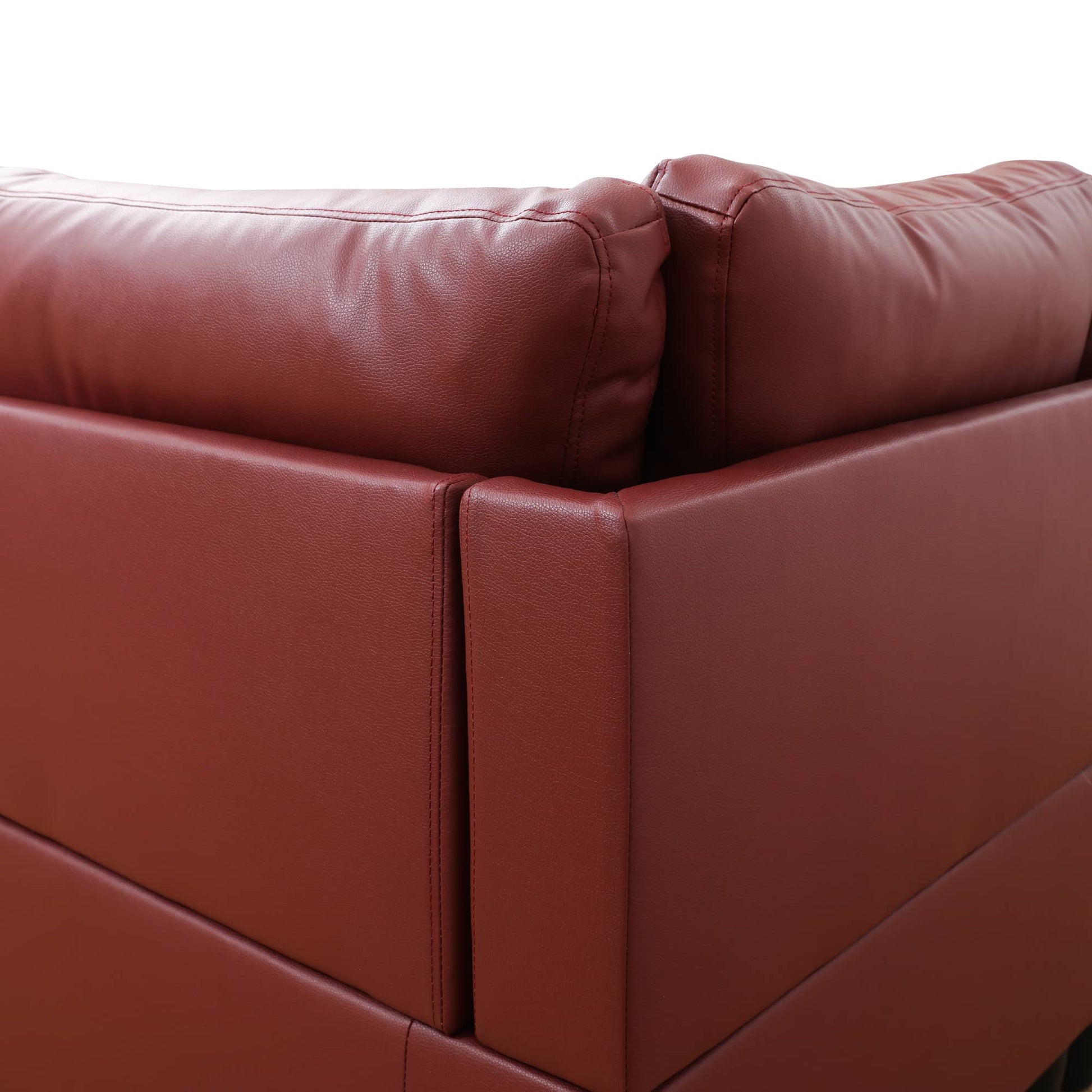 Red leather sectional sofa corner with stitched details
