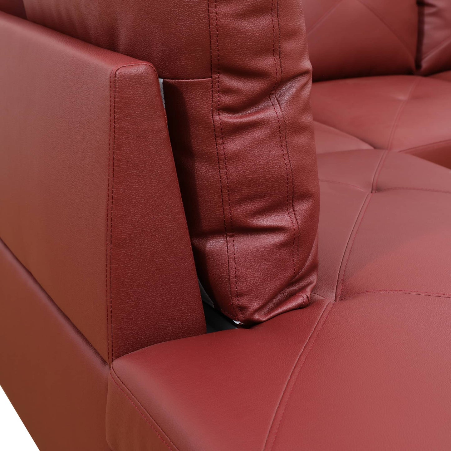 Red leather sofa detail with prominent stitching