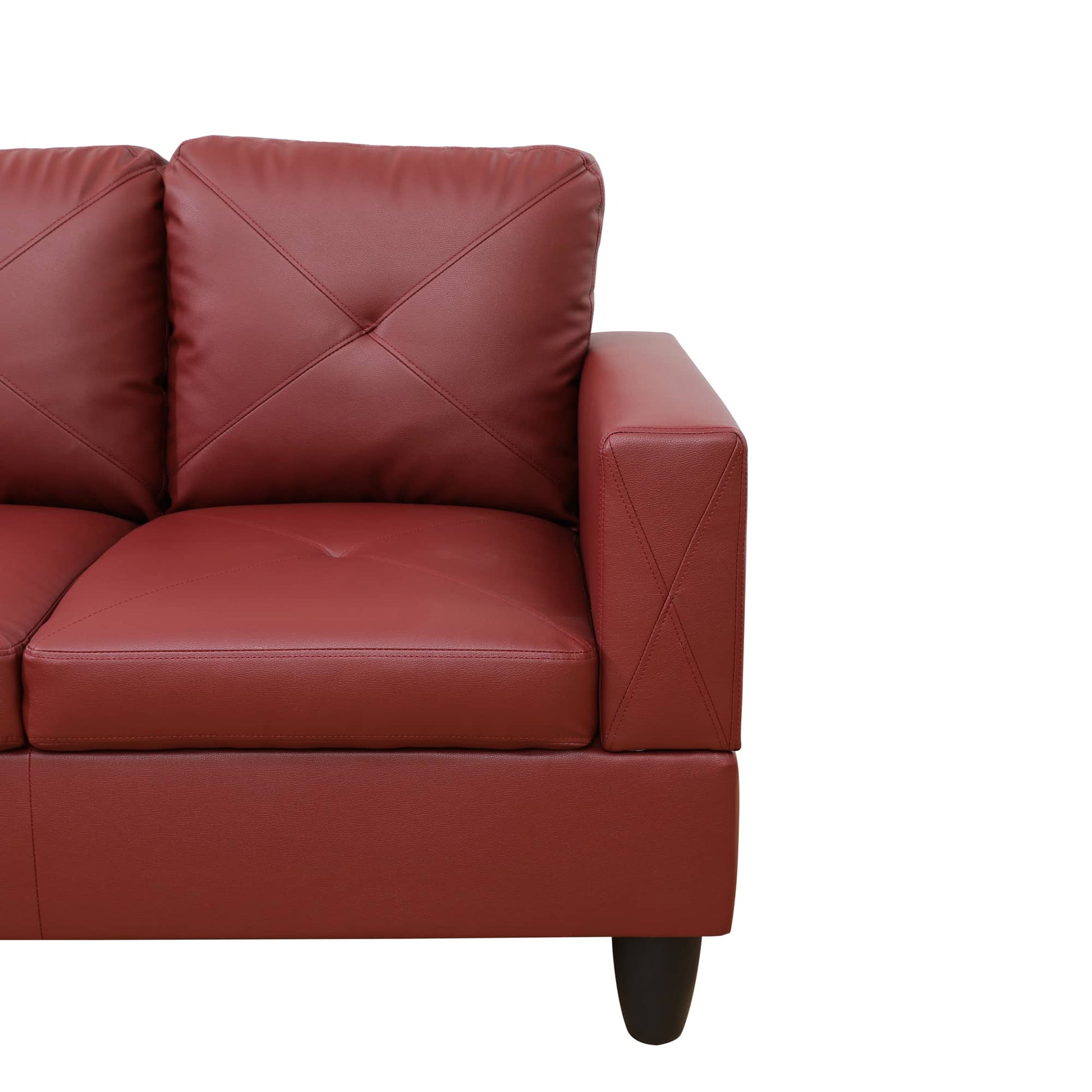 Red leather sofa arm with diamond tufting detail and black tapered leg