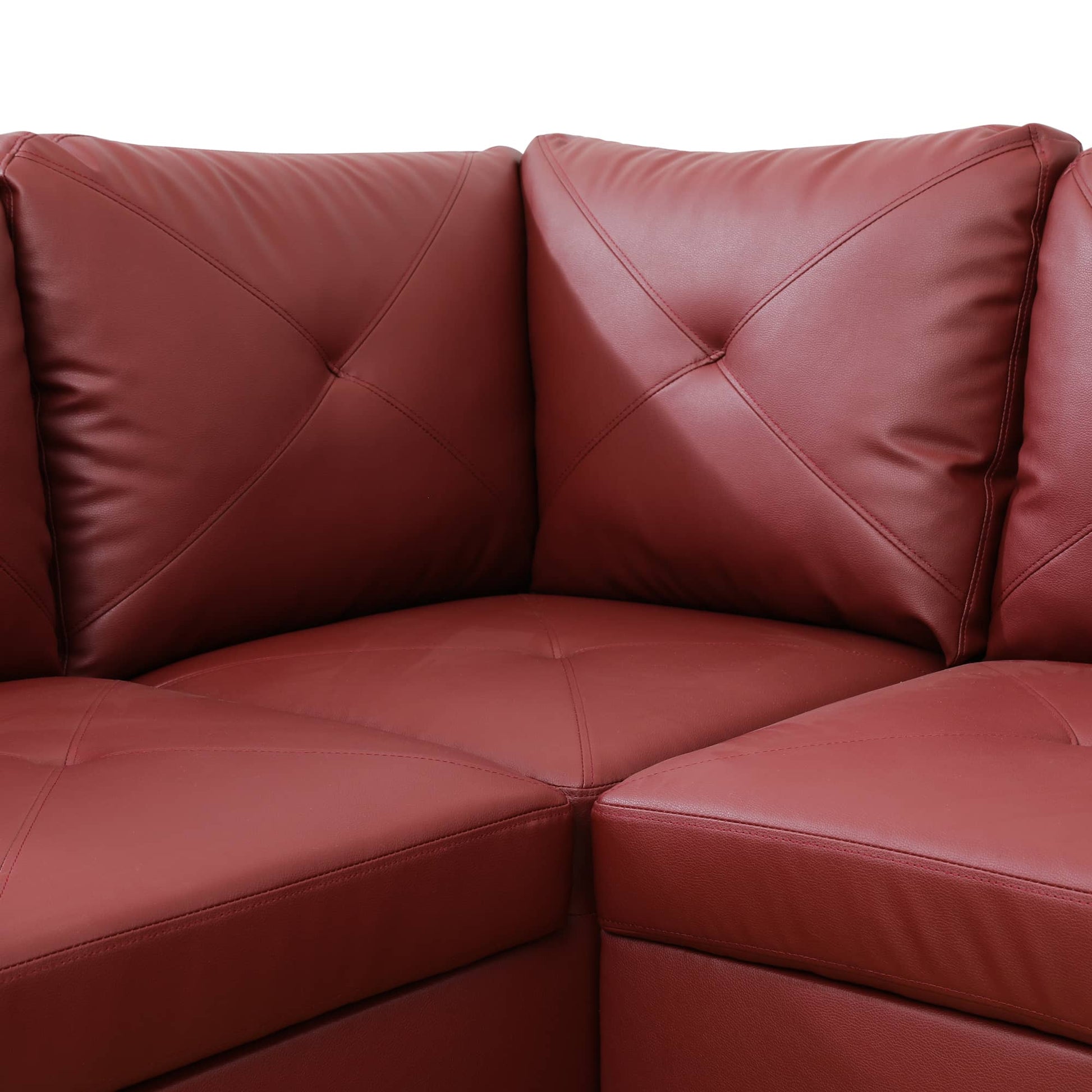 Deep red leather sectional sofa with tufted cushions and diamond stitching