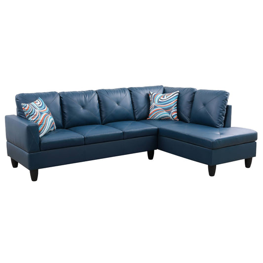 Deep blue faux leather sectional sofa with tufted cushions and abstract patterned throw pillows