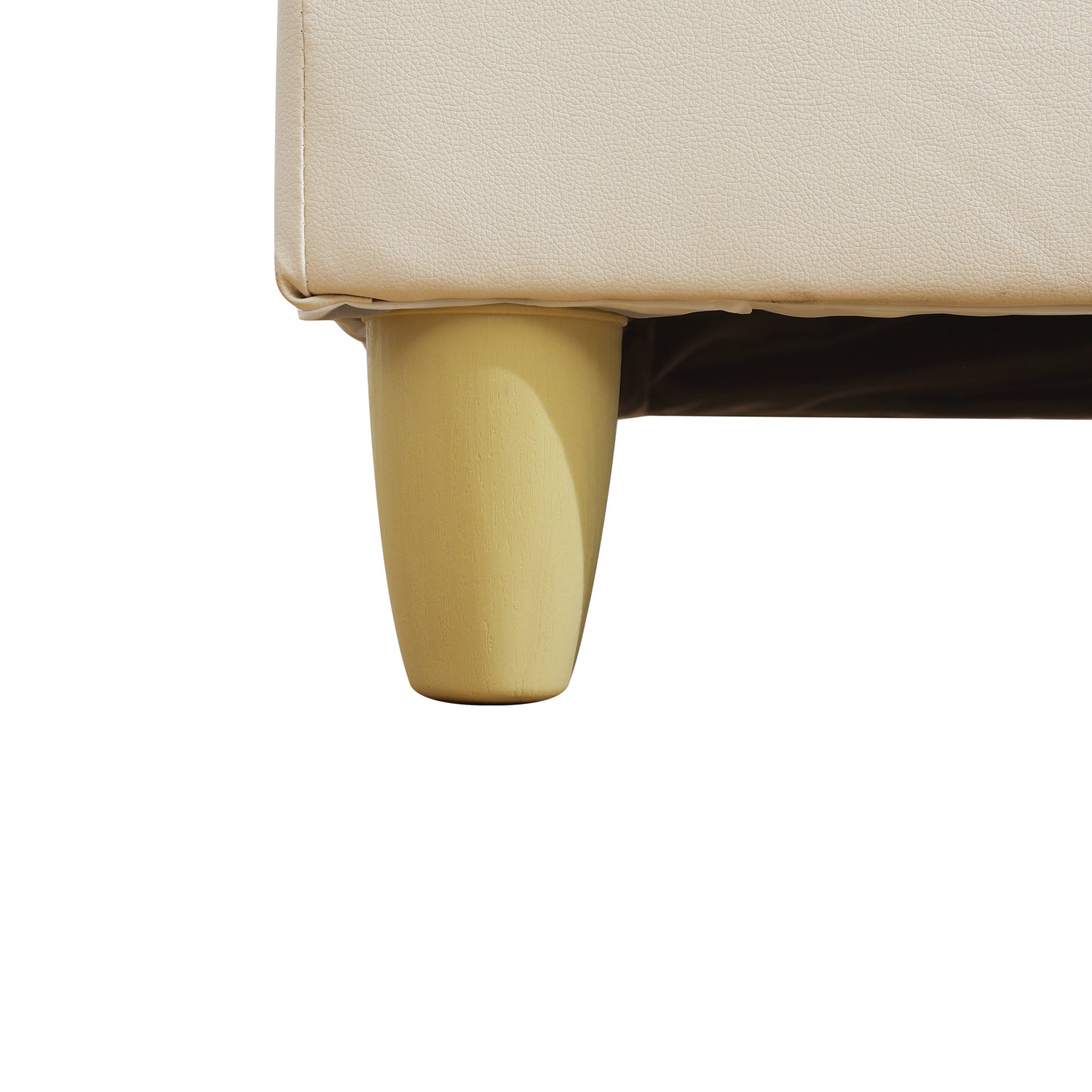 Cream faux leather sofa corner with tapered wooden leg