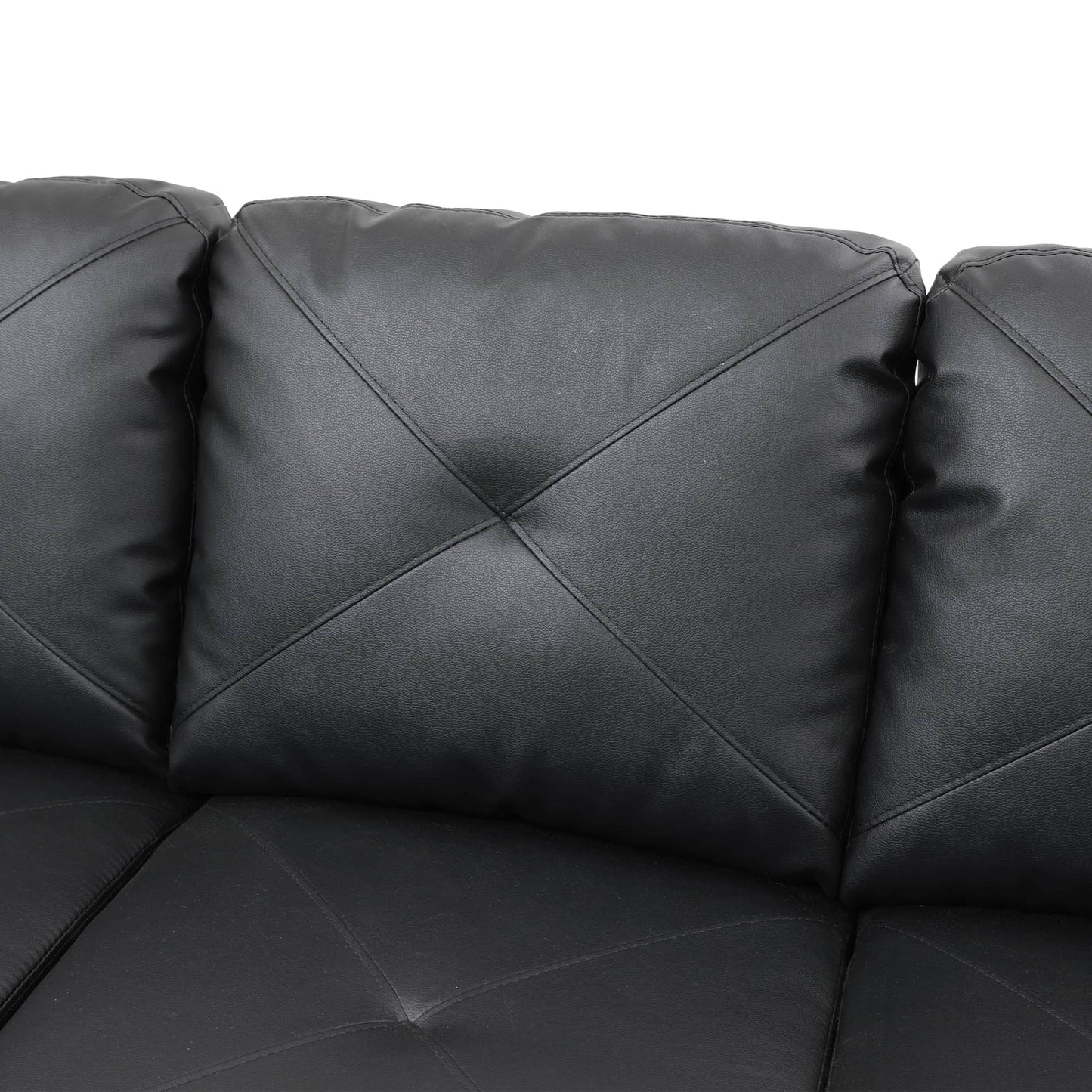Black faux leather sofa with tufted cushions
