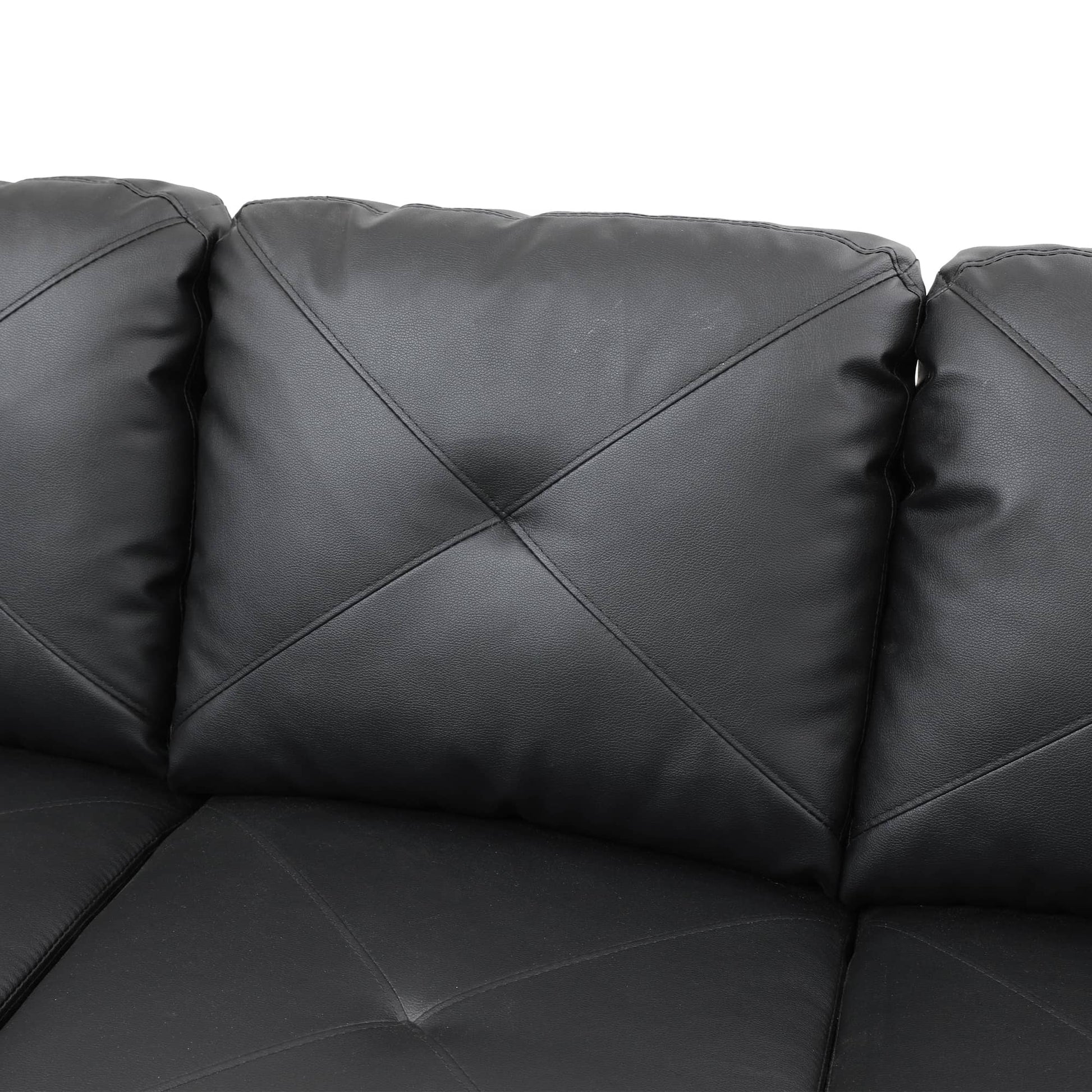 Black faux leather sofa with tufted cushions