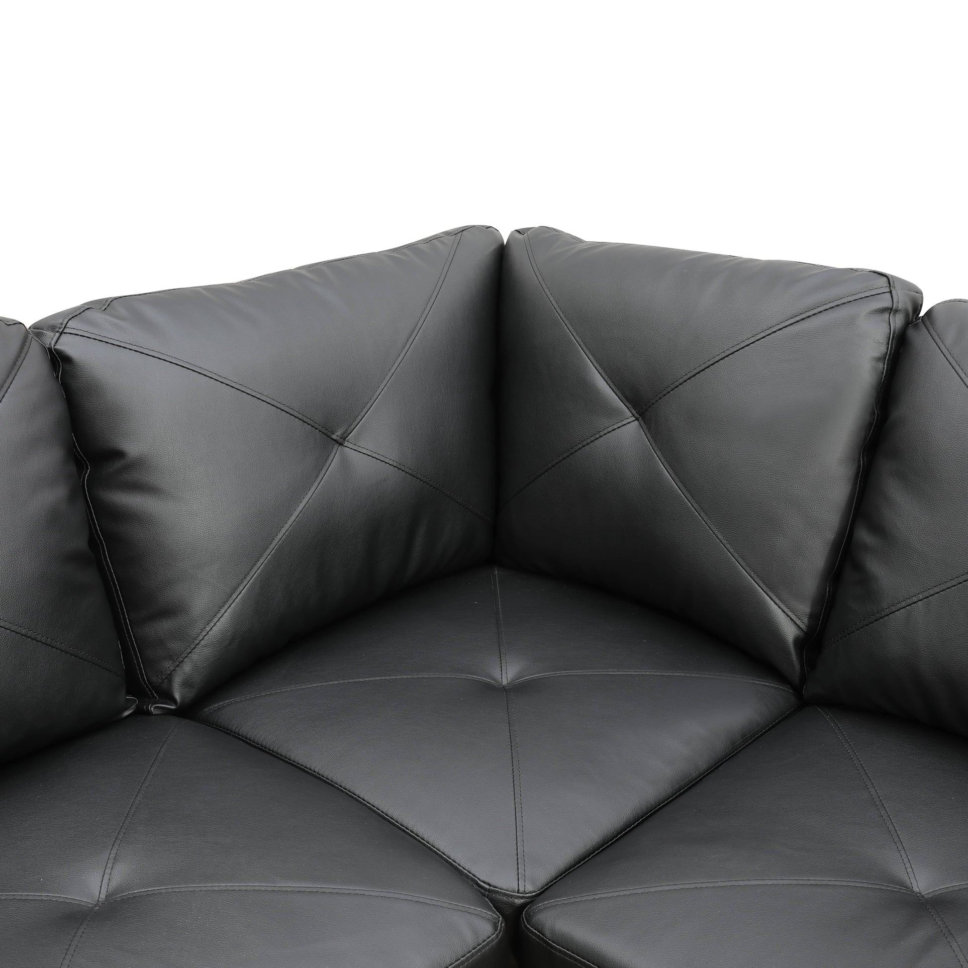 Black faux leather sectional sofa corner with diamond tufting