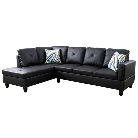 Black faux leather sectional sofa with tufted cushions and decorative pillows