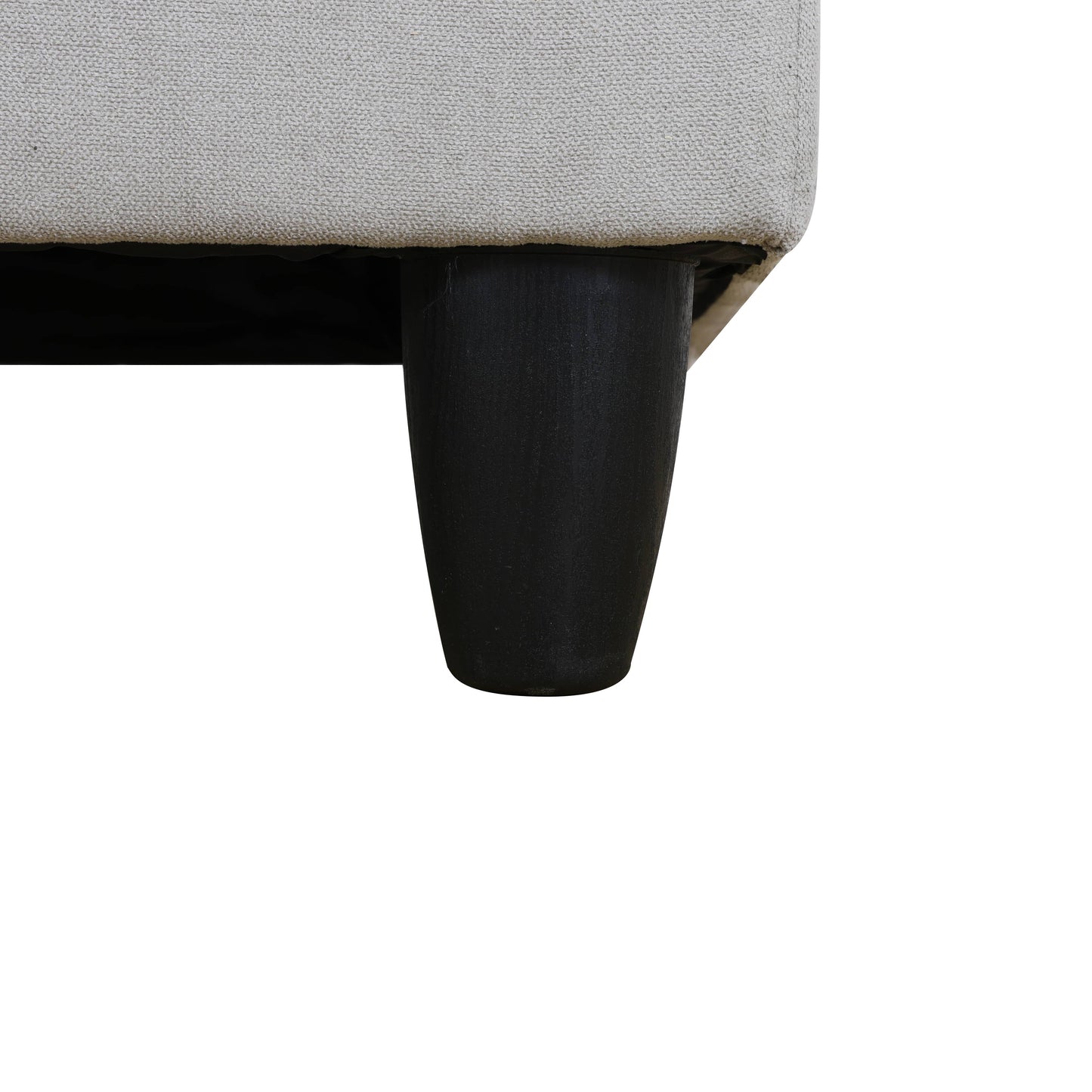 Cream textured fabric sofa detail with black tapered leg