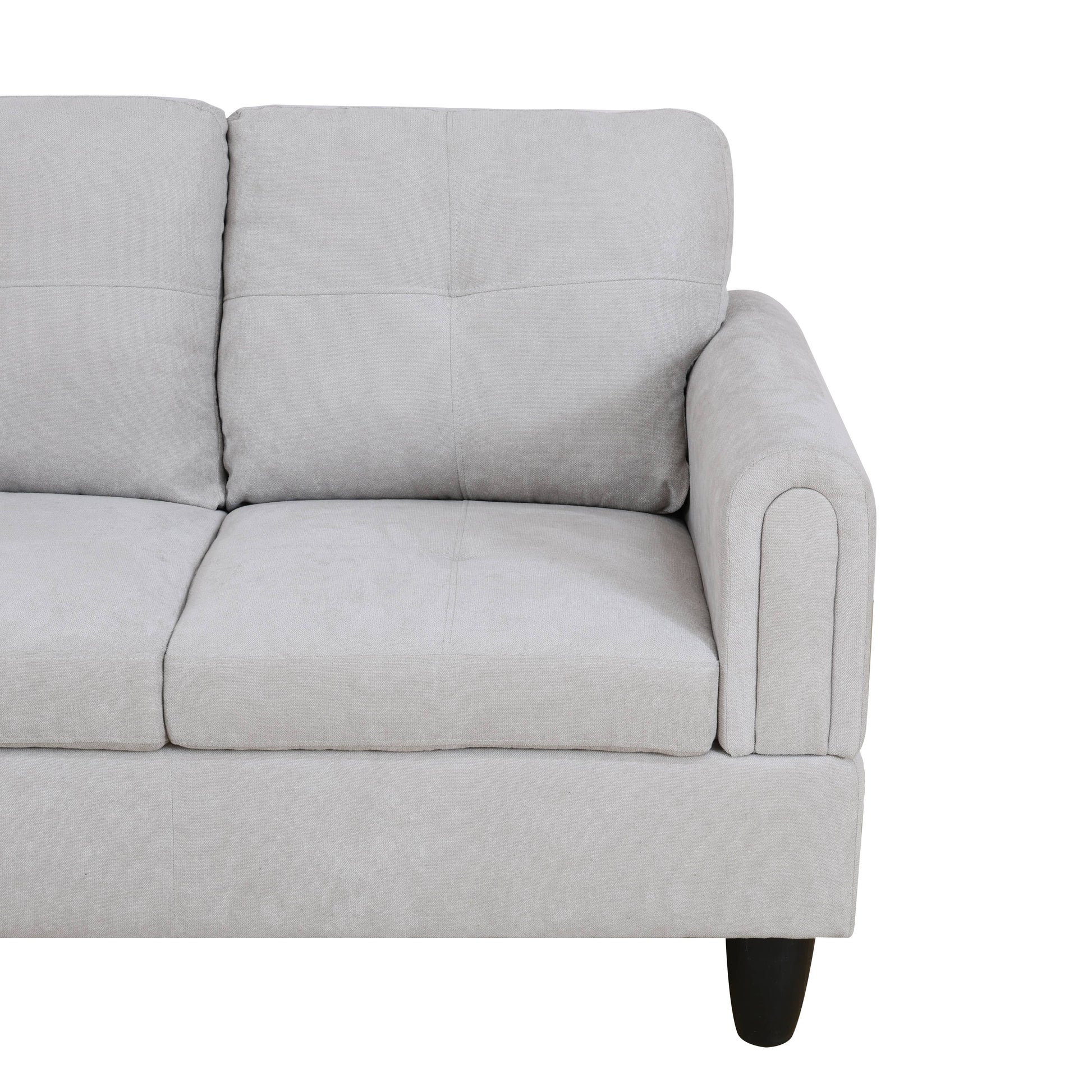 Light gray fabric sofa with tufted back cushions and curved armrest