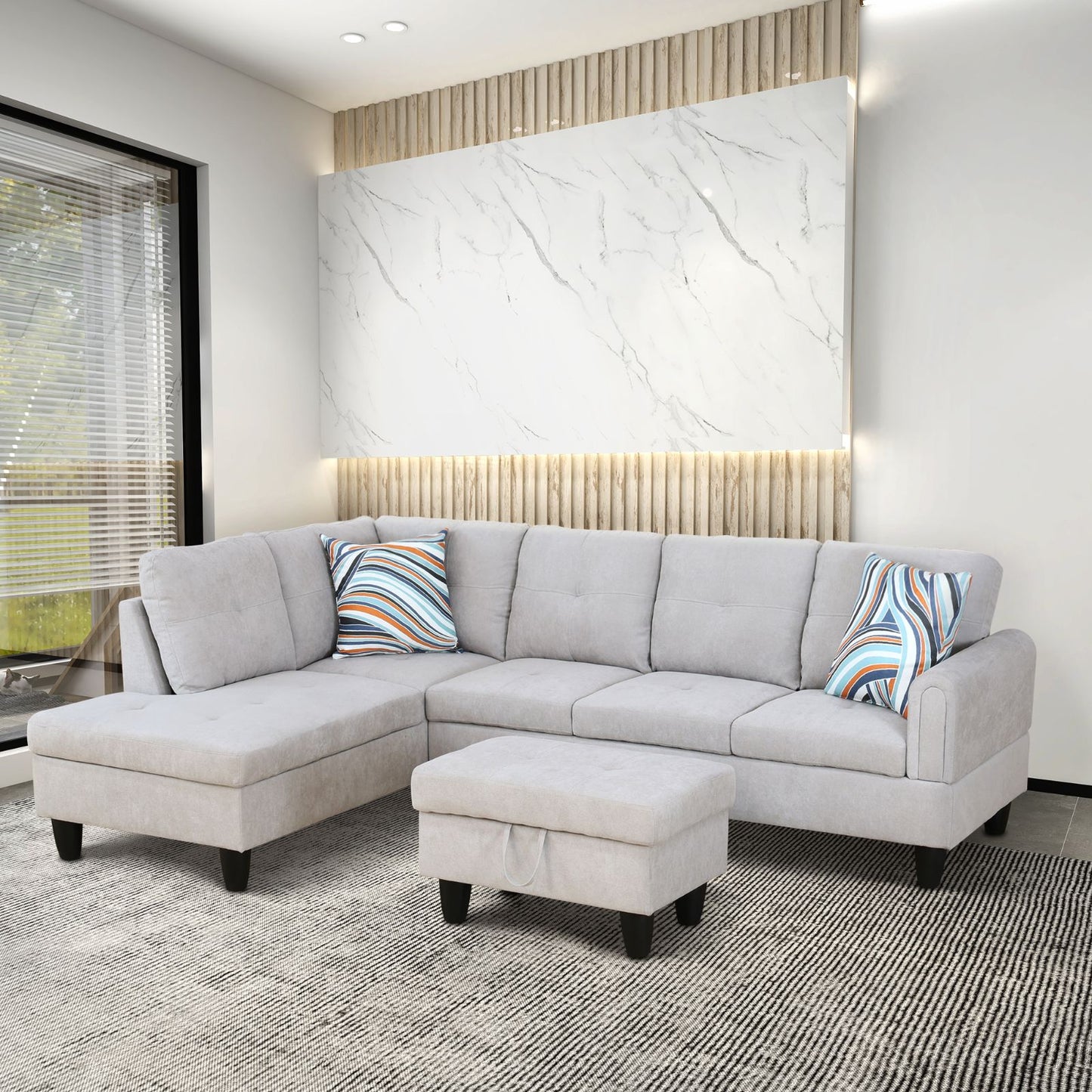 Light gray fabric sectional sofa with matching ottoman and striped throw pillows