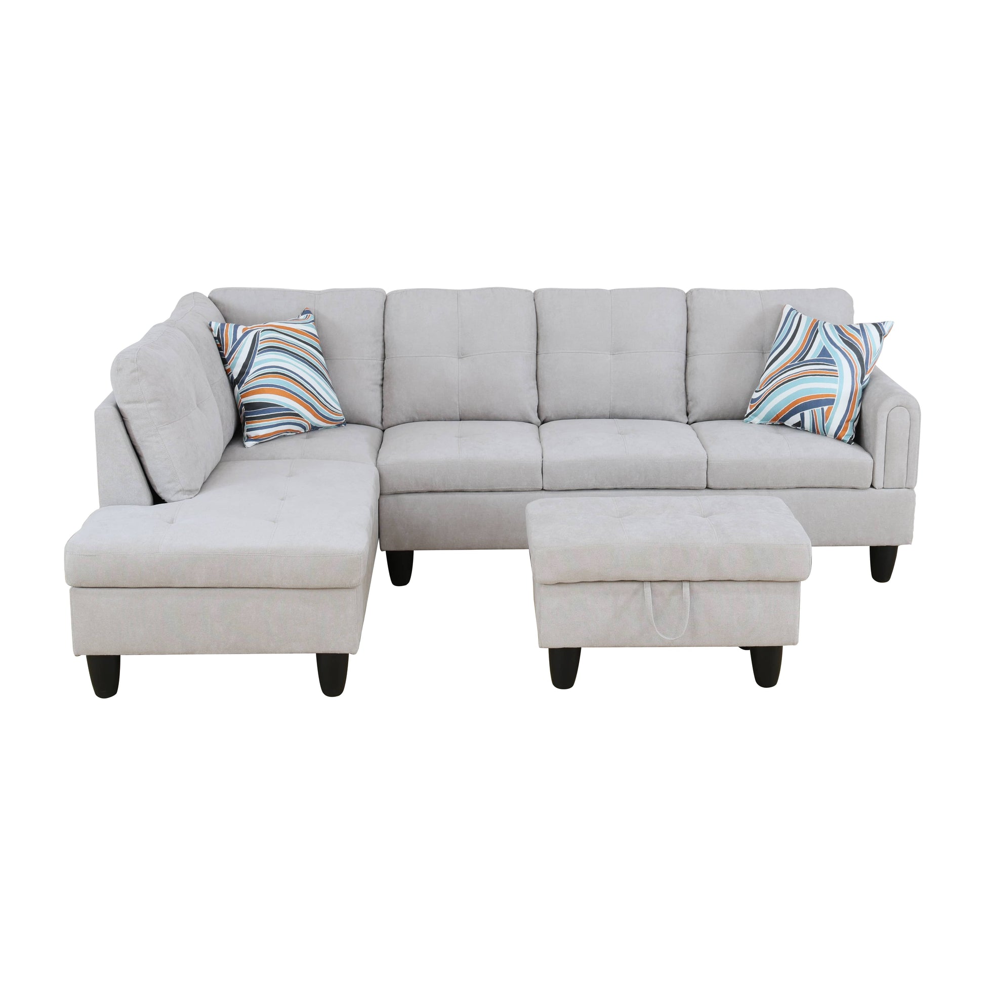 Light grey fabric sectional sofa with patterned throw pillows and matching ottoman