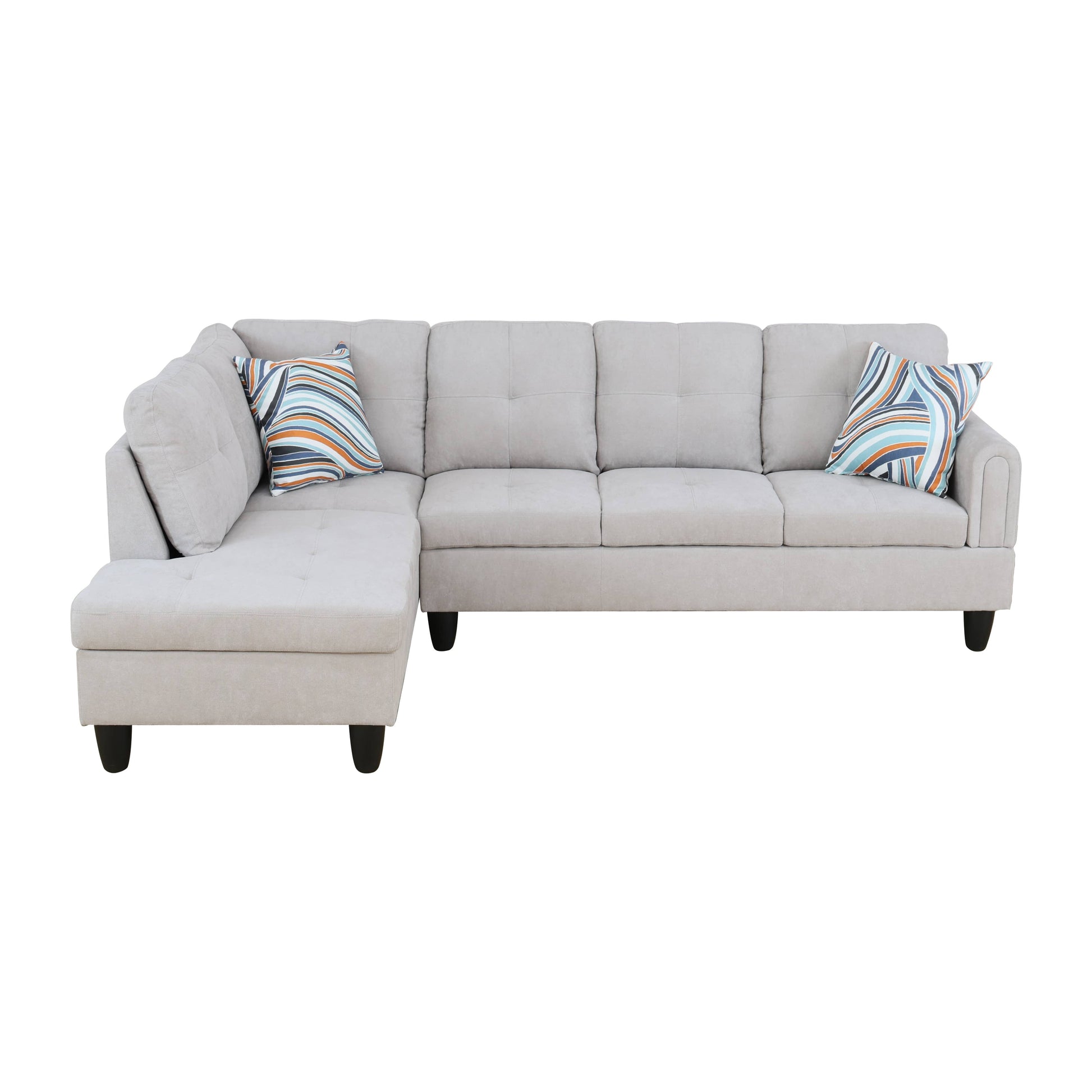 Light gray sectional sofa with tufted cushions and abstract patterned throw pillows