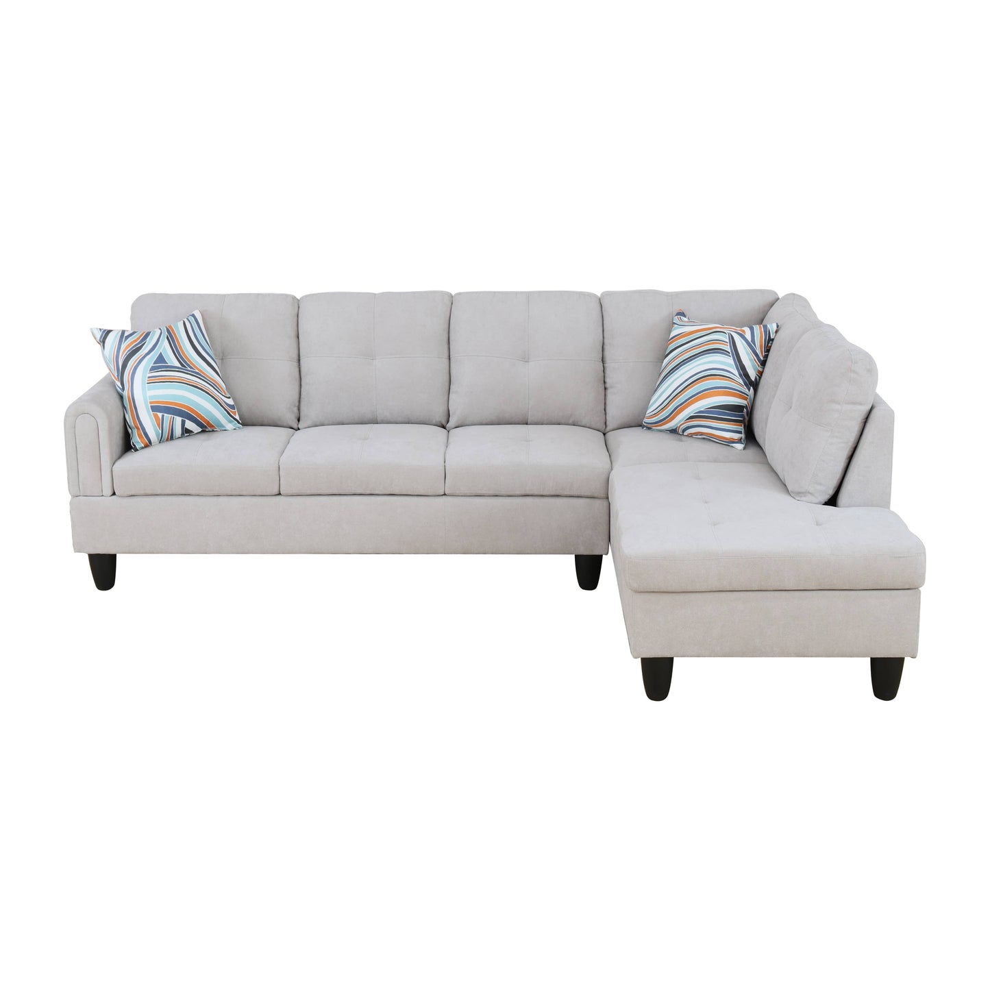 Neutral gray fabric sectional sofa with tufted cushions and geometric accent pillows