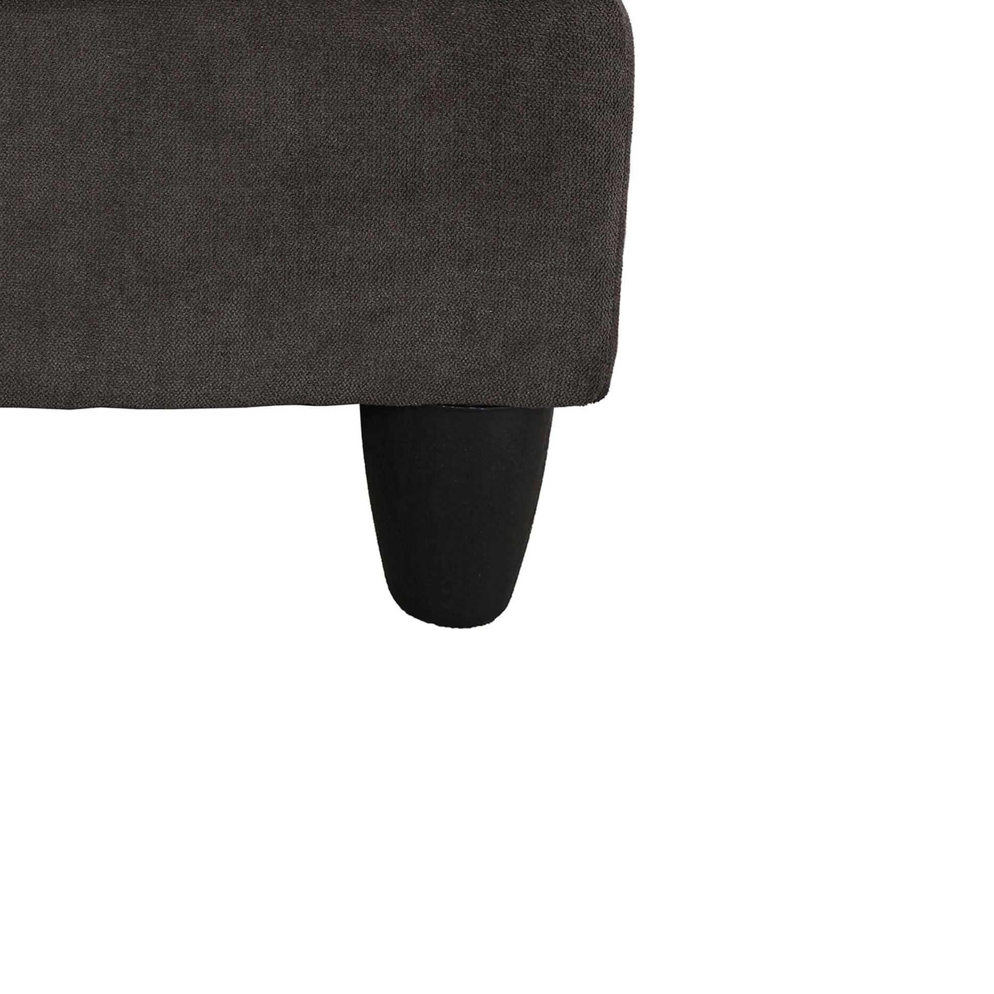 Dark brown textured fabric sofa corner with a tapered black leg