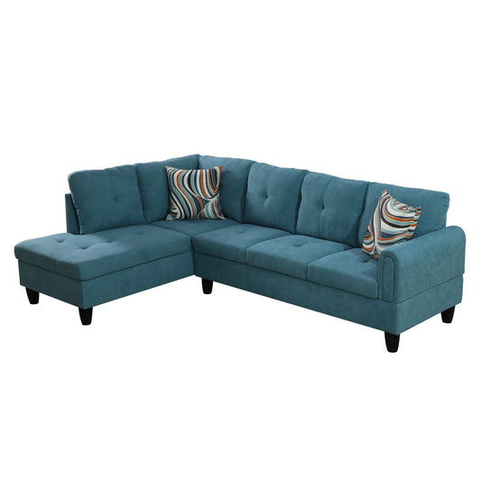 Teal fabric sectional sofa with tufted cushions and abstract patterned throw pillows