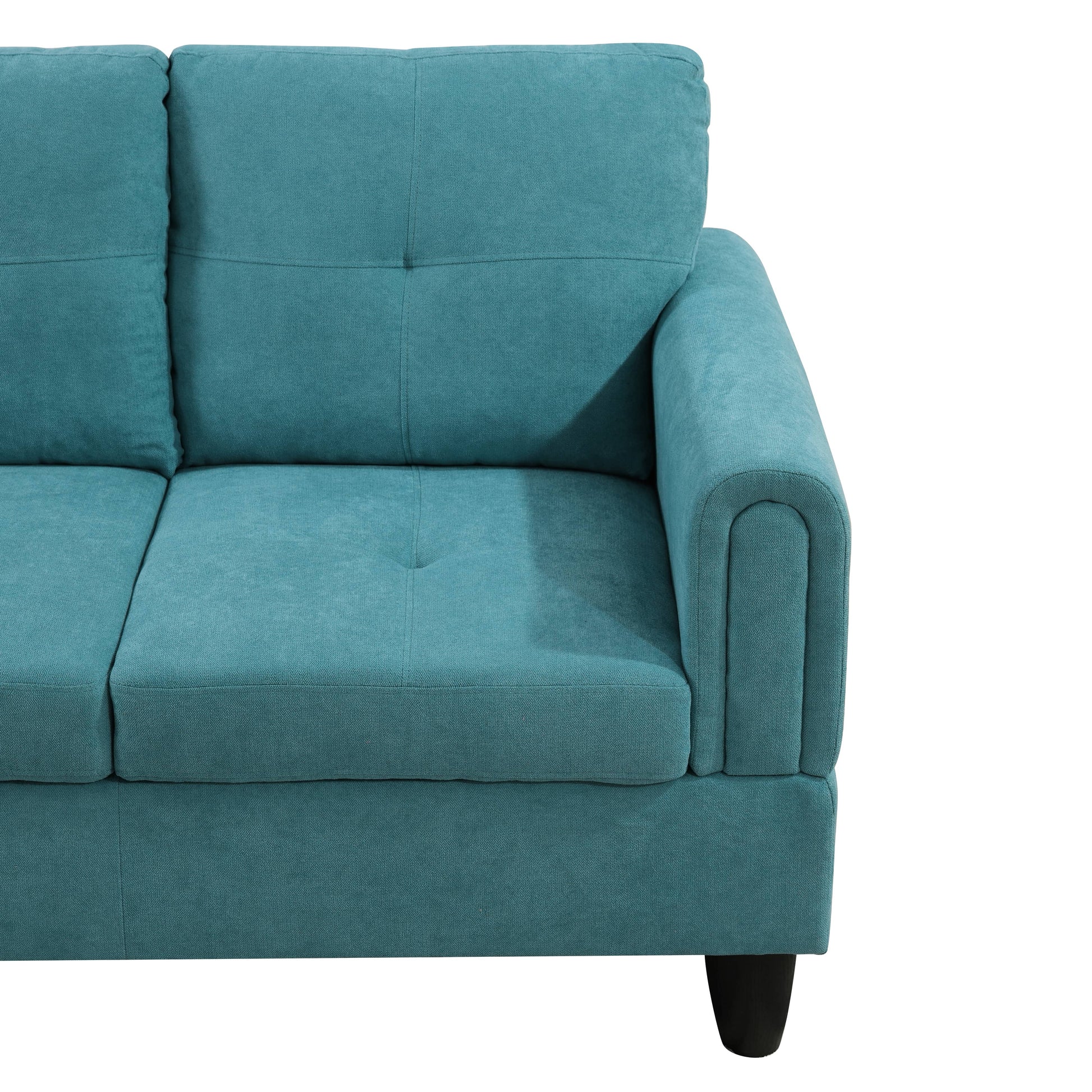 Teal upholstered sofa with tufted back cushions and rolled armrest