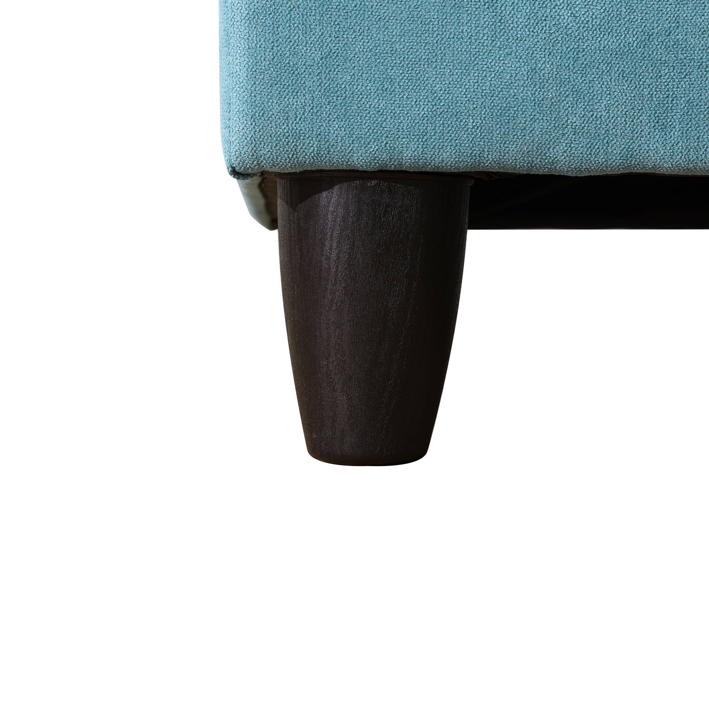 Closeup of textured teal fabric on a sofa with a dark wooden tapered leg