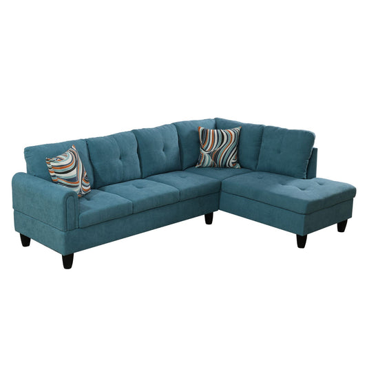 Teal fabric sectional sofa with tufted cushions and decorative throw pillows