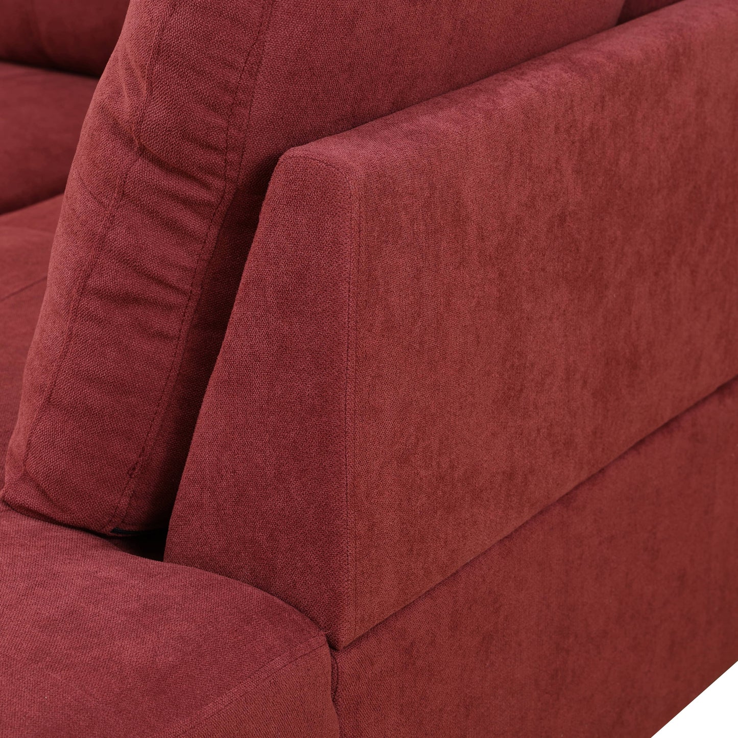 Deep red textured fabric sofa corner detail