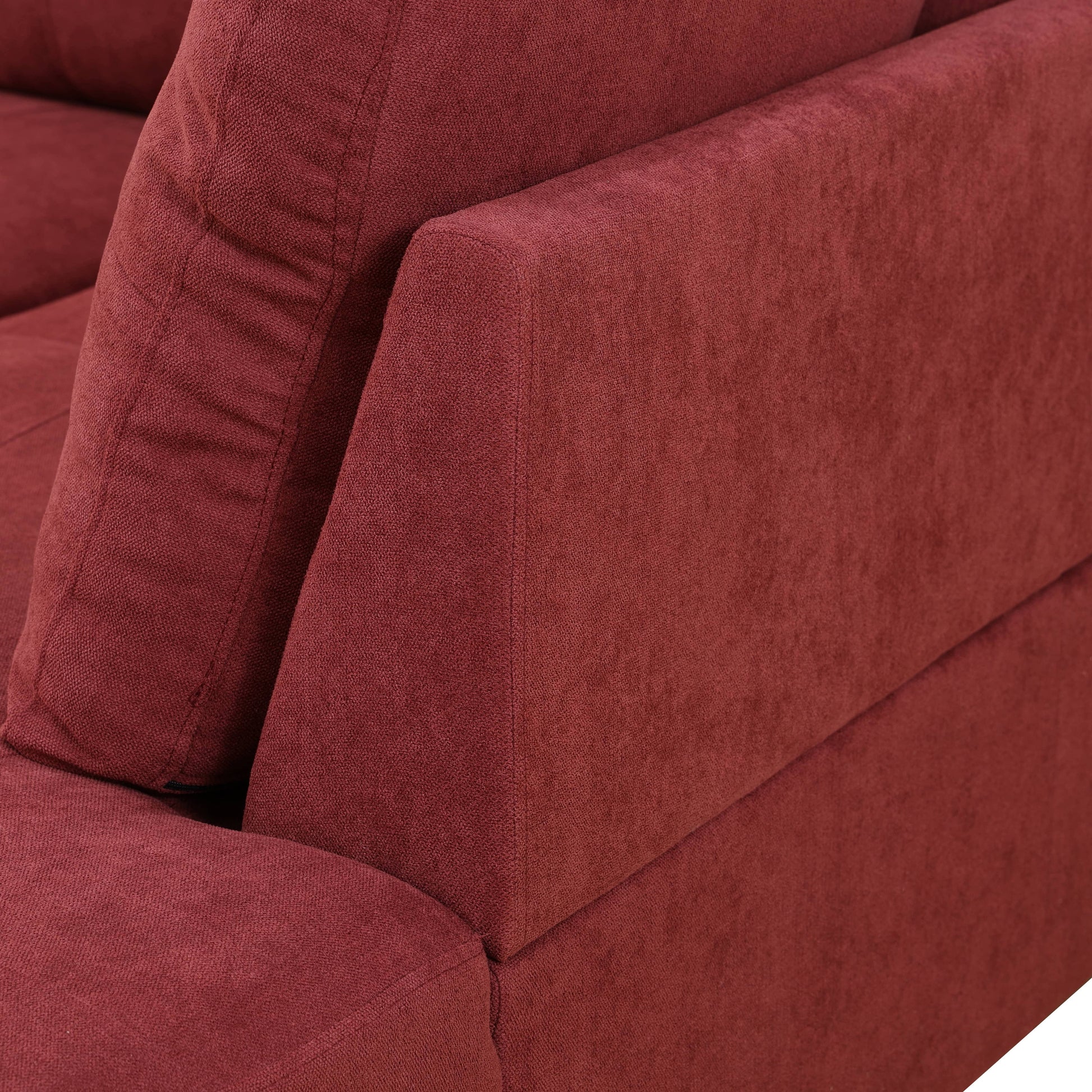 Deep red textured fabric sofa corner detail
