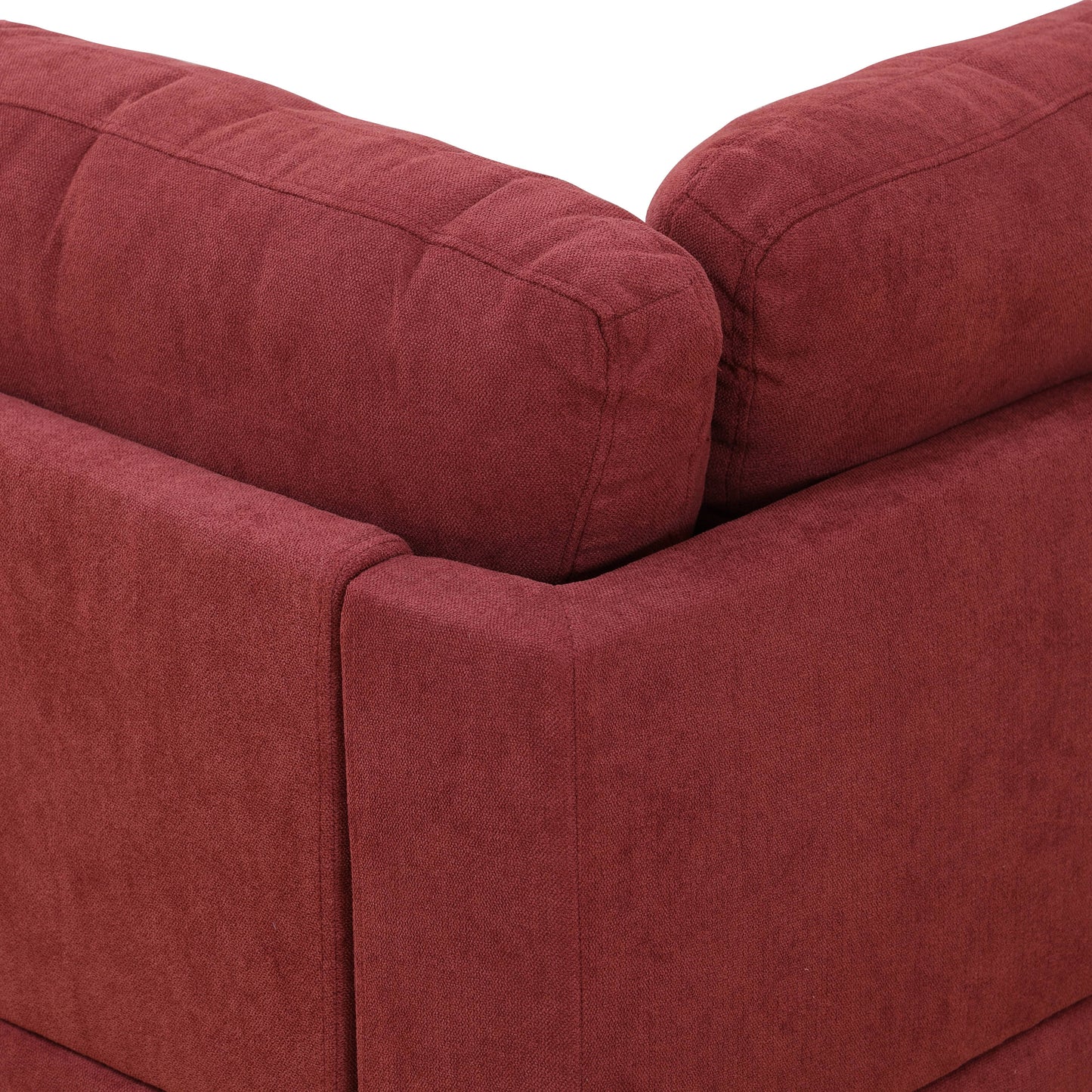 Burgundy tufted fabric sofa corner detail