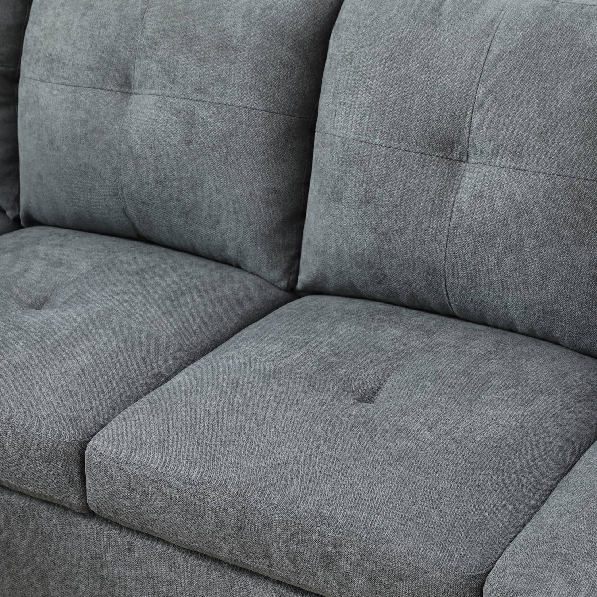Closeup of grey fabric sofa cushions with diamond tufting