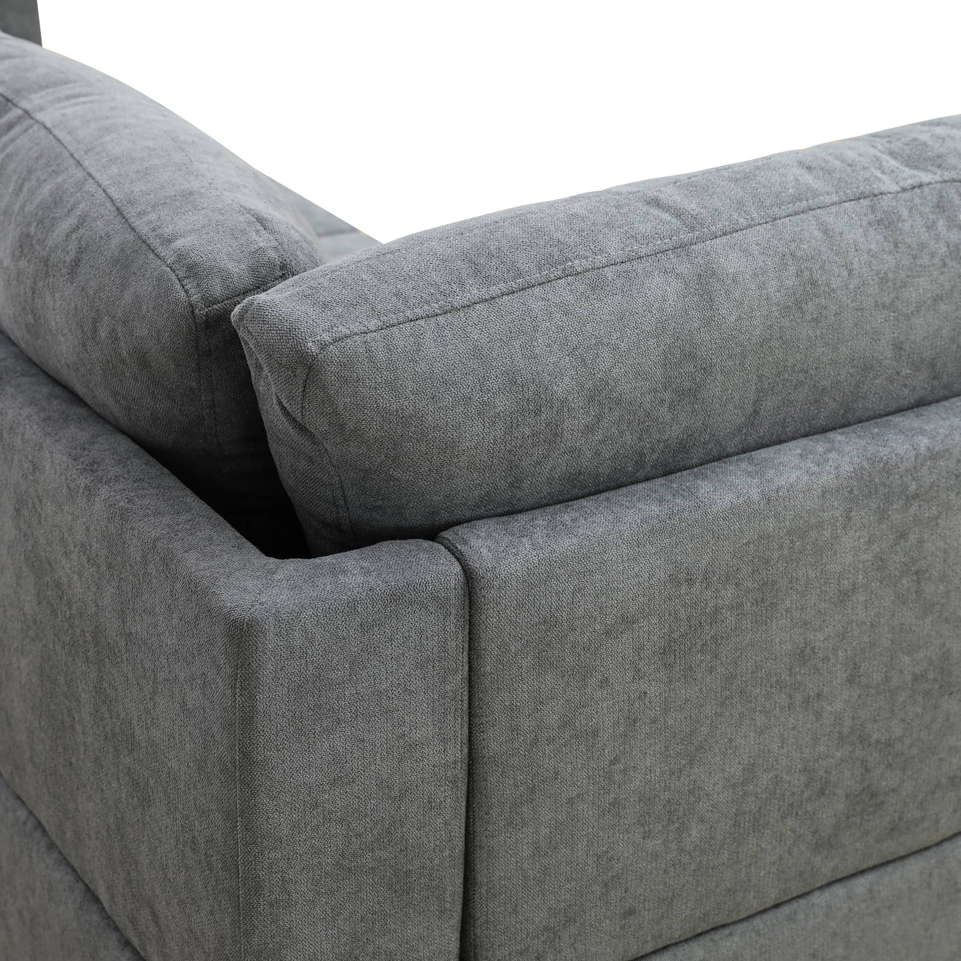 Closeup of a charcoal grey fabric sectional sofas armrest