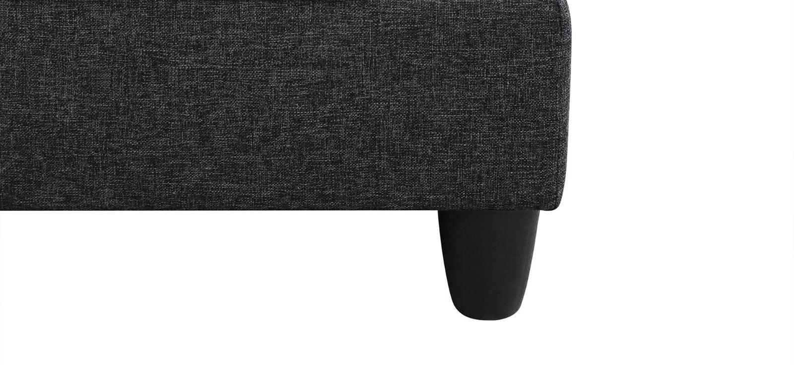 Dark grey textured sofa fabric detail with a tapered black leg