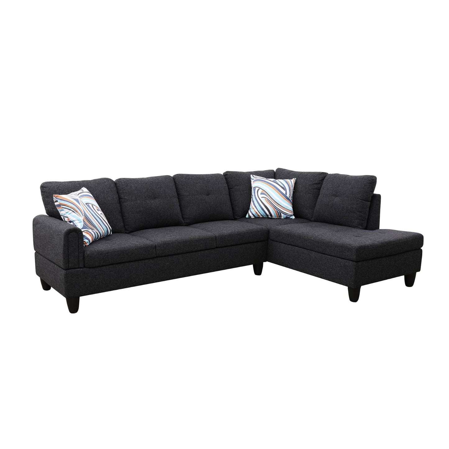 Dark grey fabric sectional sofa with modern tufted cushions and abstract print pillows