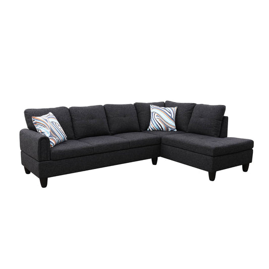 Dark grey fabric sectional sofa with modern tufted cushions and abstract print pillows