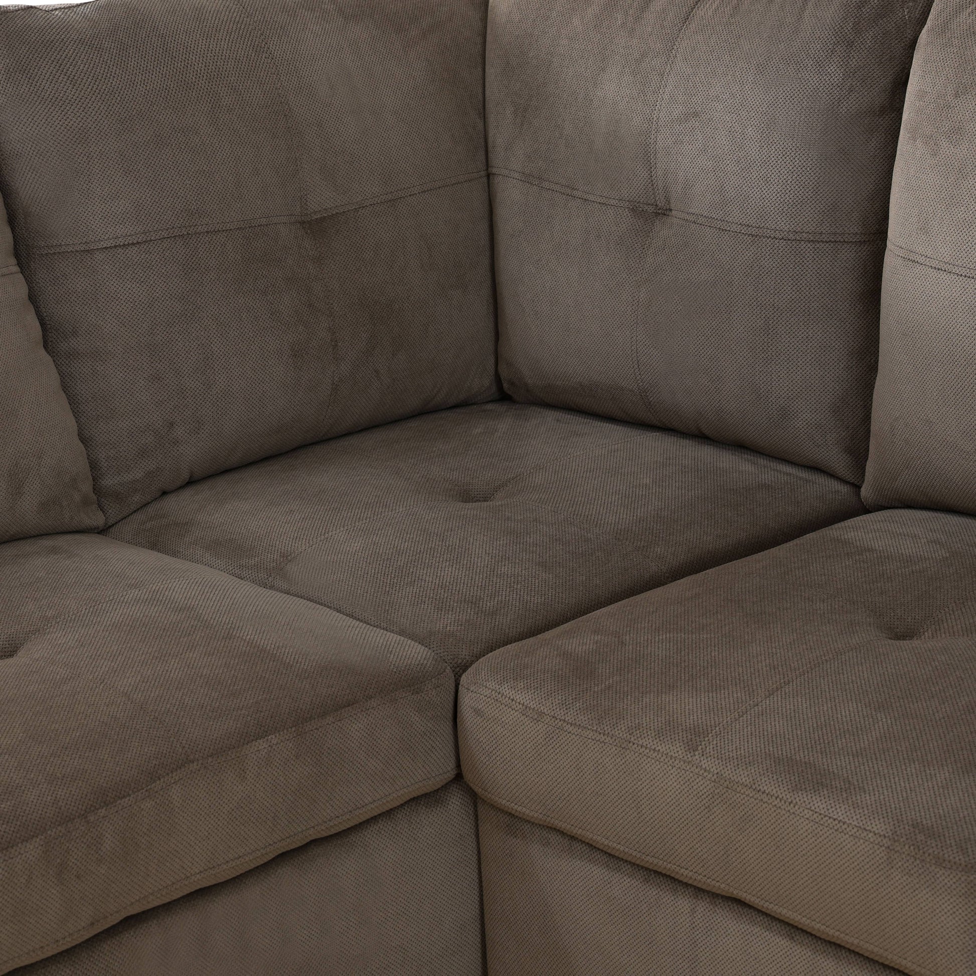 Plush brown fabric sectional sofa corner detail