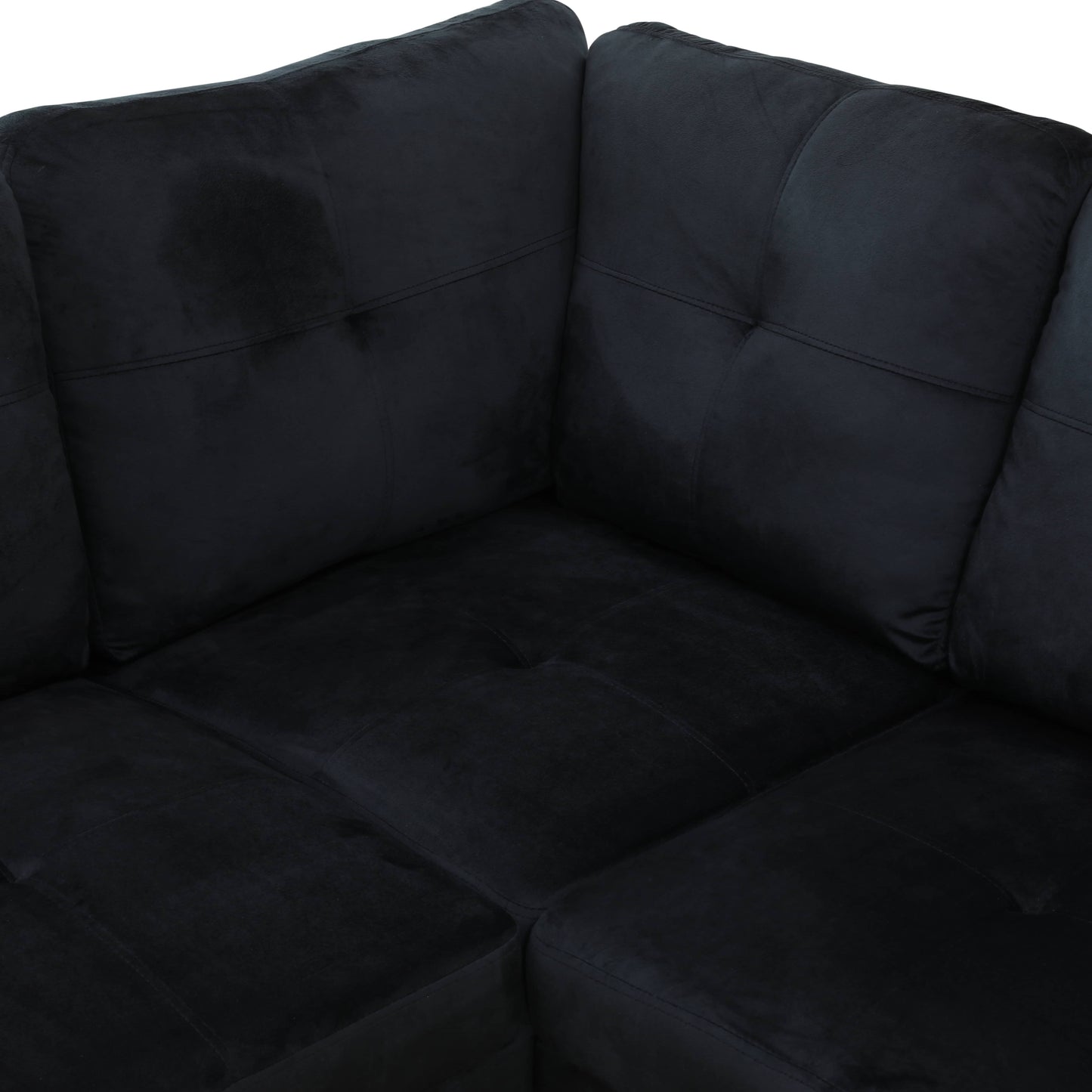 Black velvet sectional sofa with deep tufted cushions