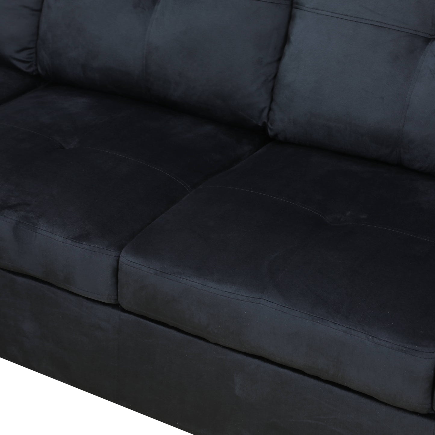 Closeup of a plush black fabric sofa with tufted back cushions