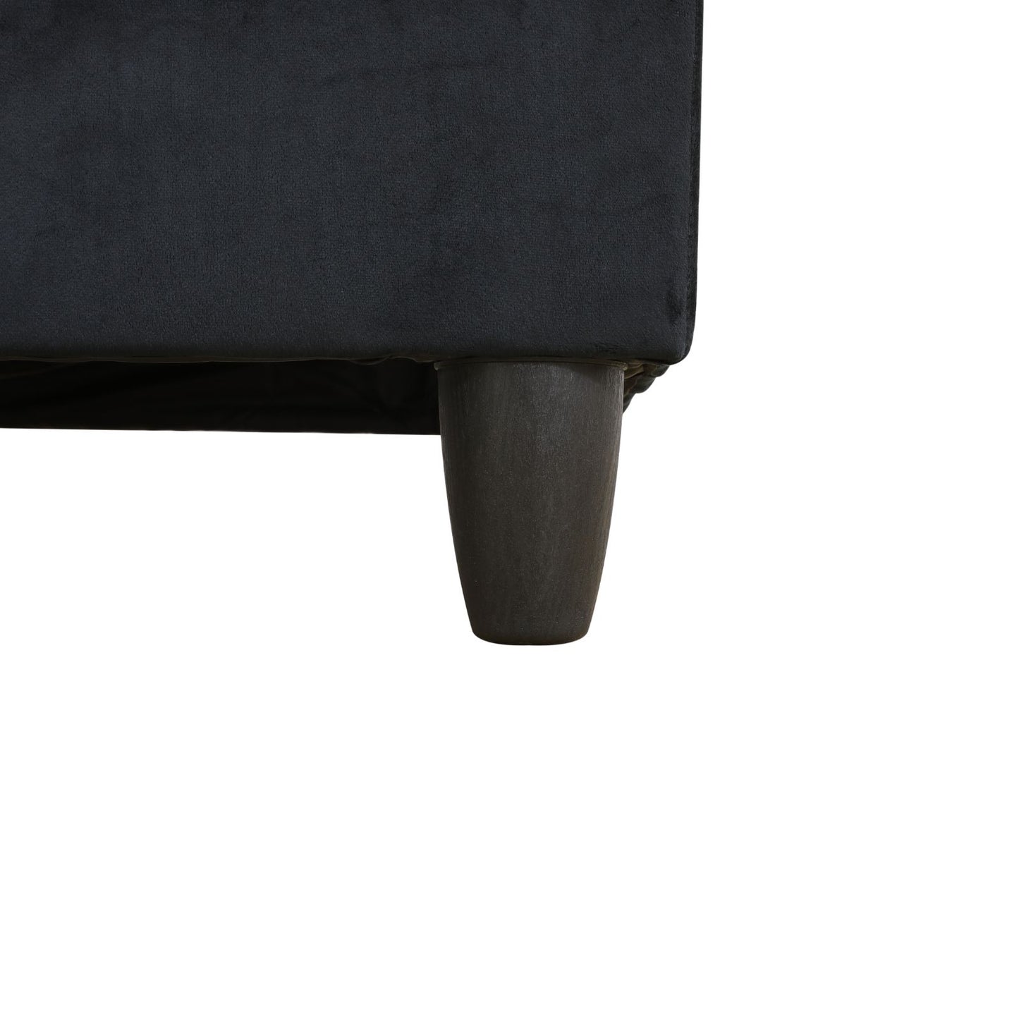Closeup of dark grey velvet sofa leg on white background