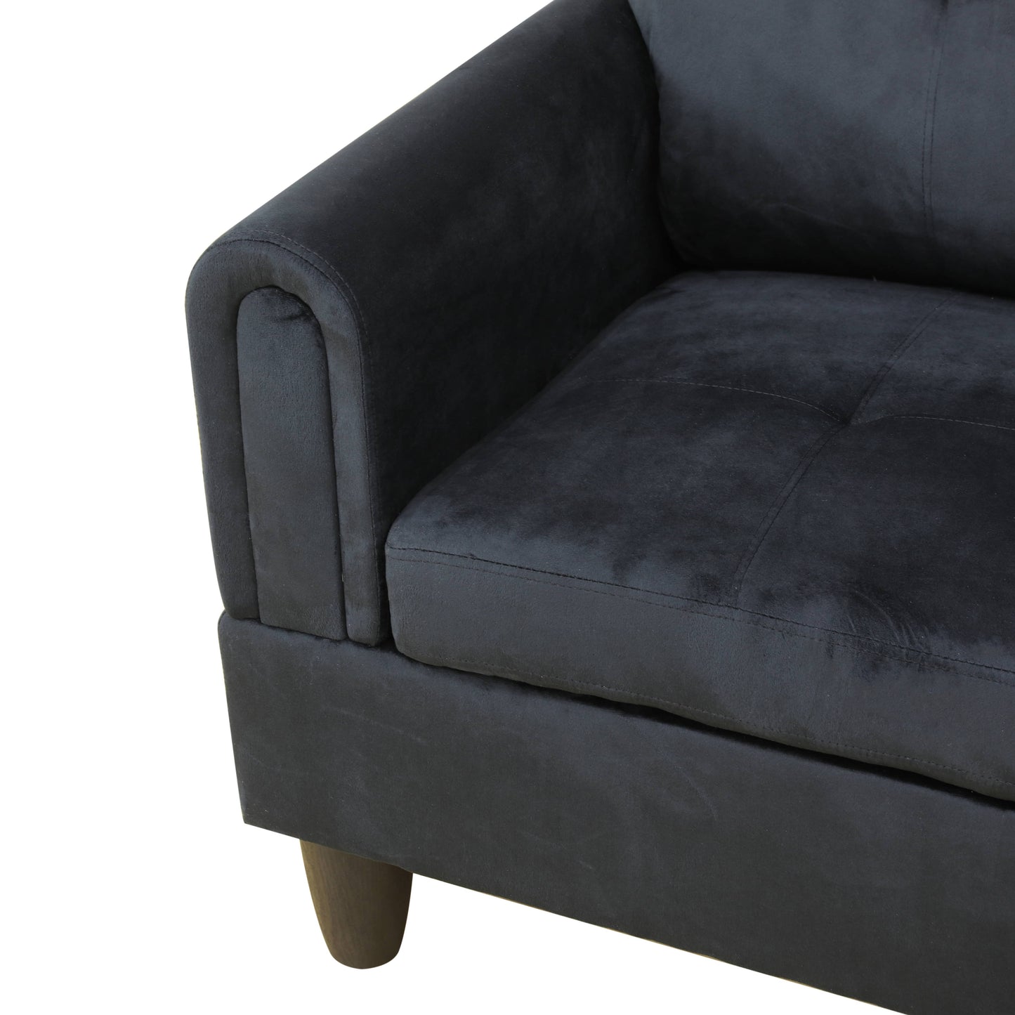 Dark gray velvet sofa armrest with tufted seat detail