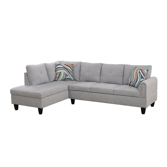 Gray fabric sectional sofa with two decorative pillows and tapered black legs