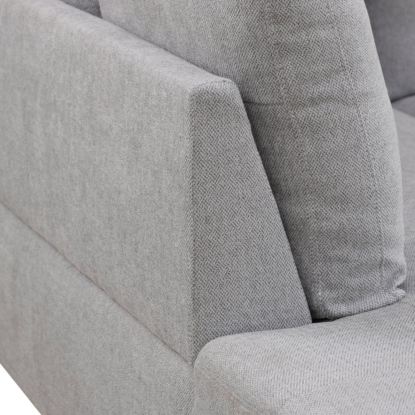 Closeup of textured grey fabric sofa armrest